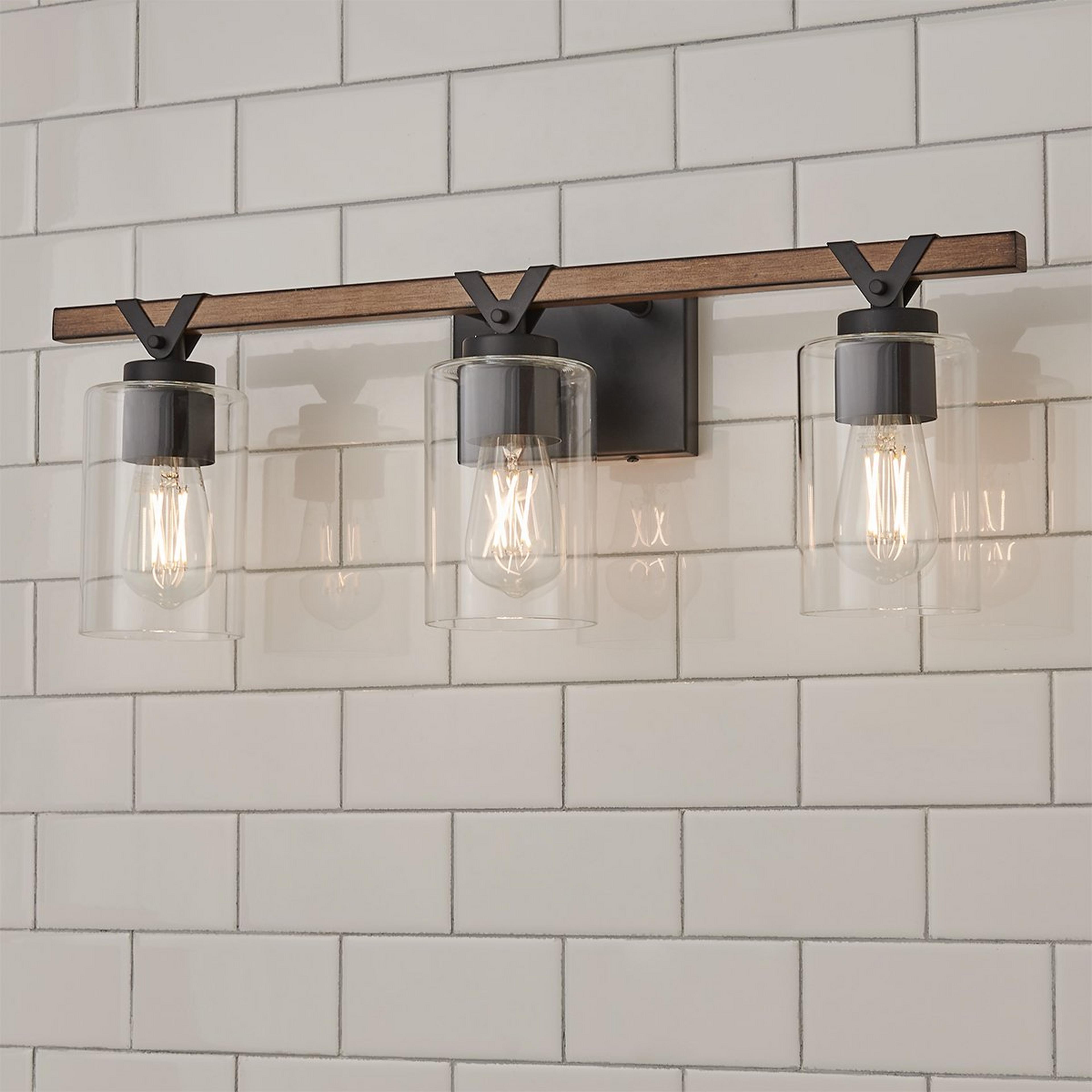 A Zaxton Vanity Light - 3 Light with Matte Black / Rustic Wood / Clear Glass  color
