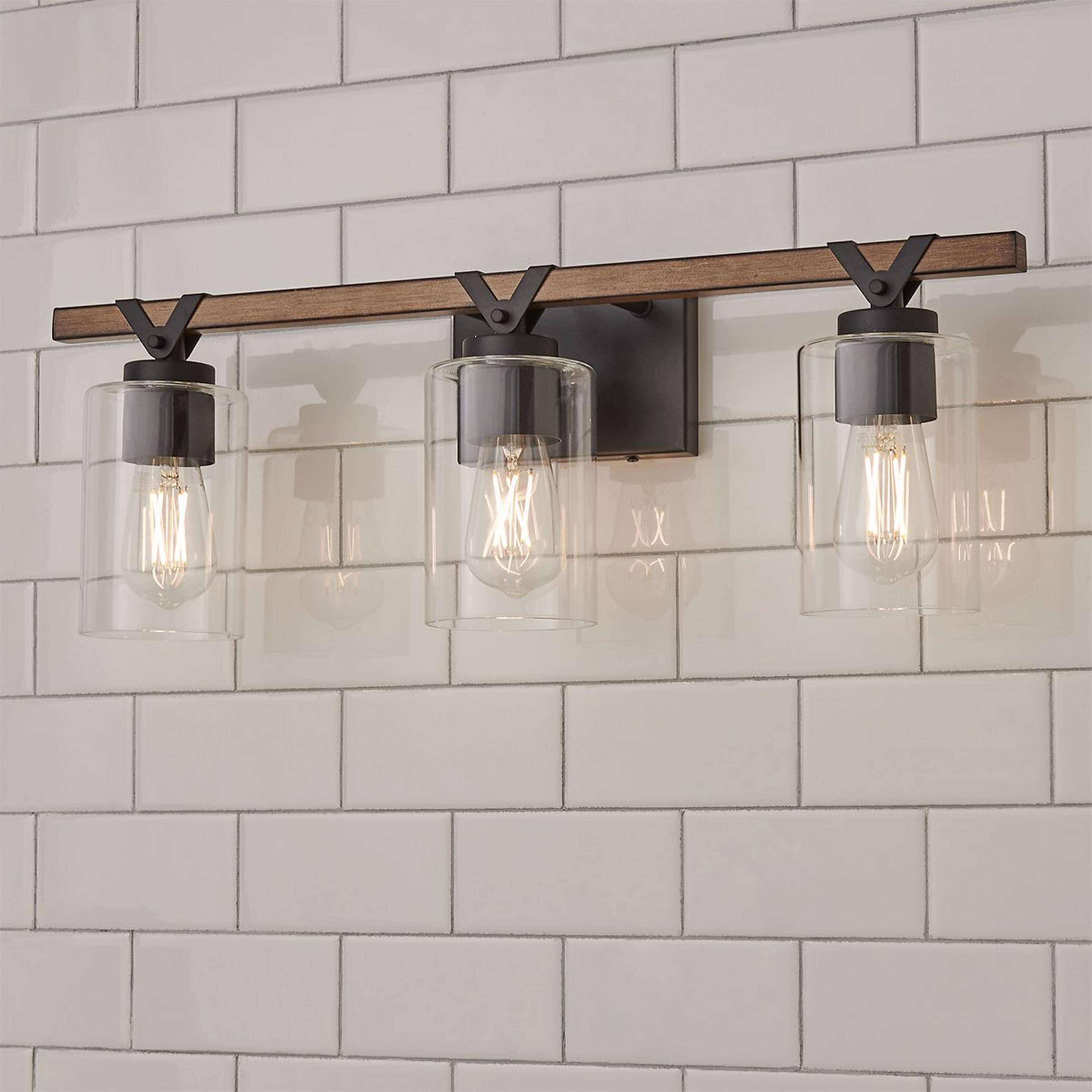 A Zaxton Vanity Light - 3 Light with Matte Black / Rustic Wood / Clear Glass color