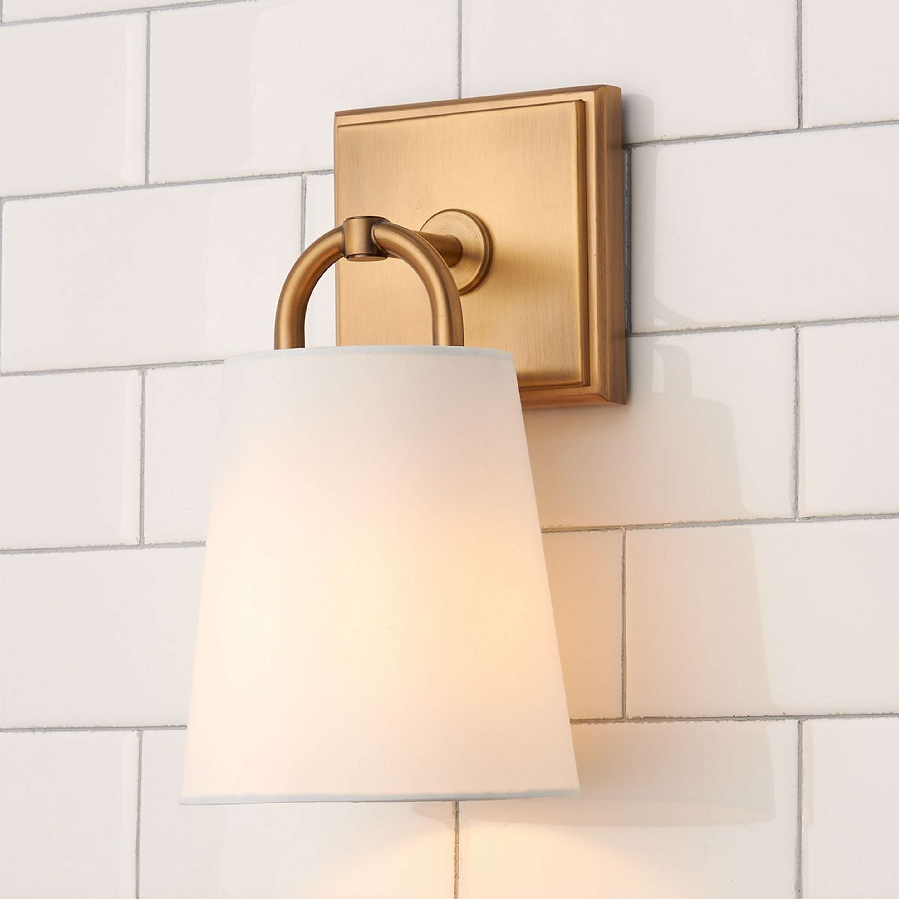 A Westchase Bath Sconce with Aged Brass / White Fabric color