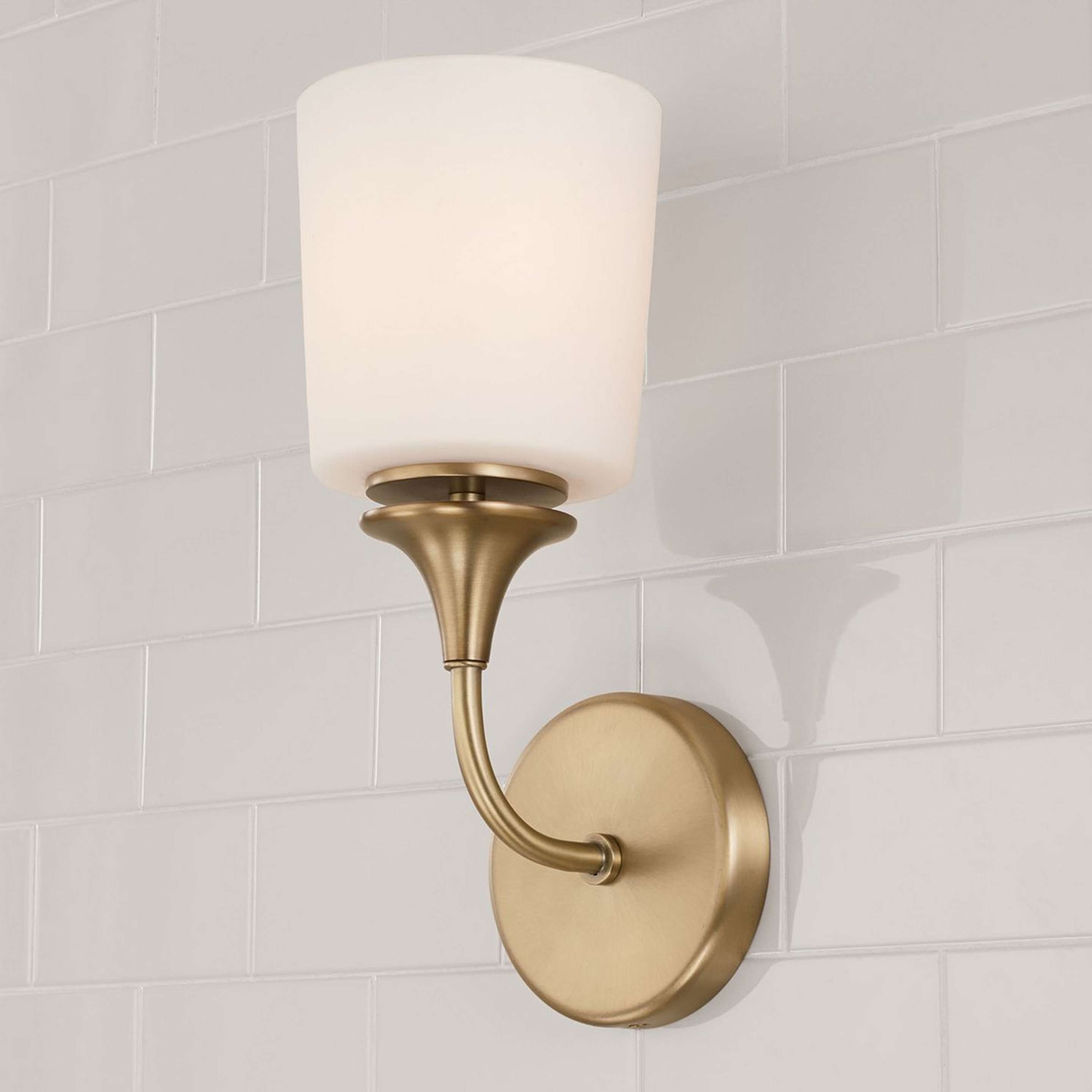 A Mayhue Bath Sconce with Aged Brass / Milk Glass color
