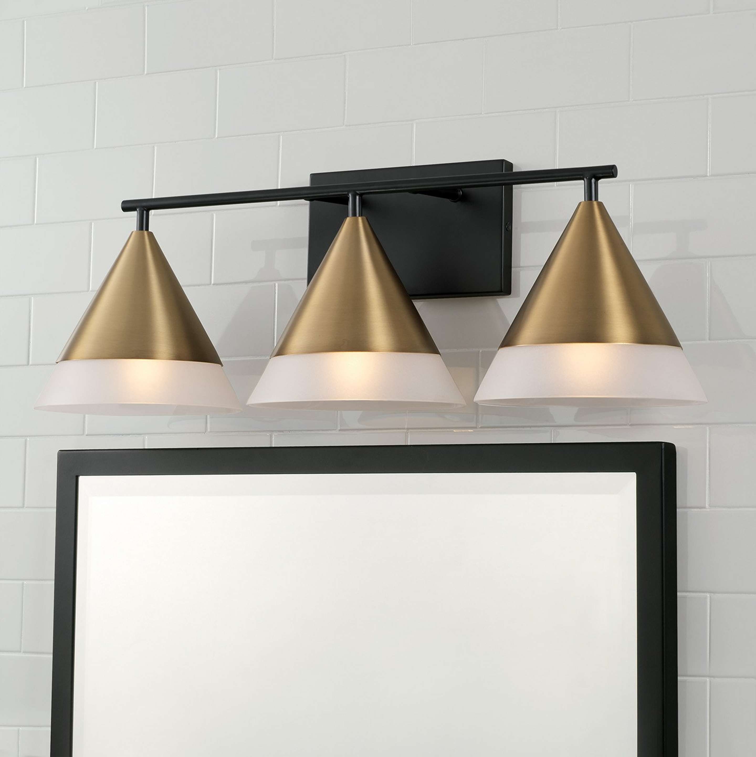 A Ylva Vanity Light with Matte Black / Aged Brass / Frosted Glass color