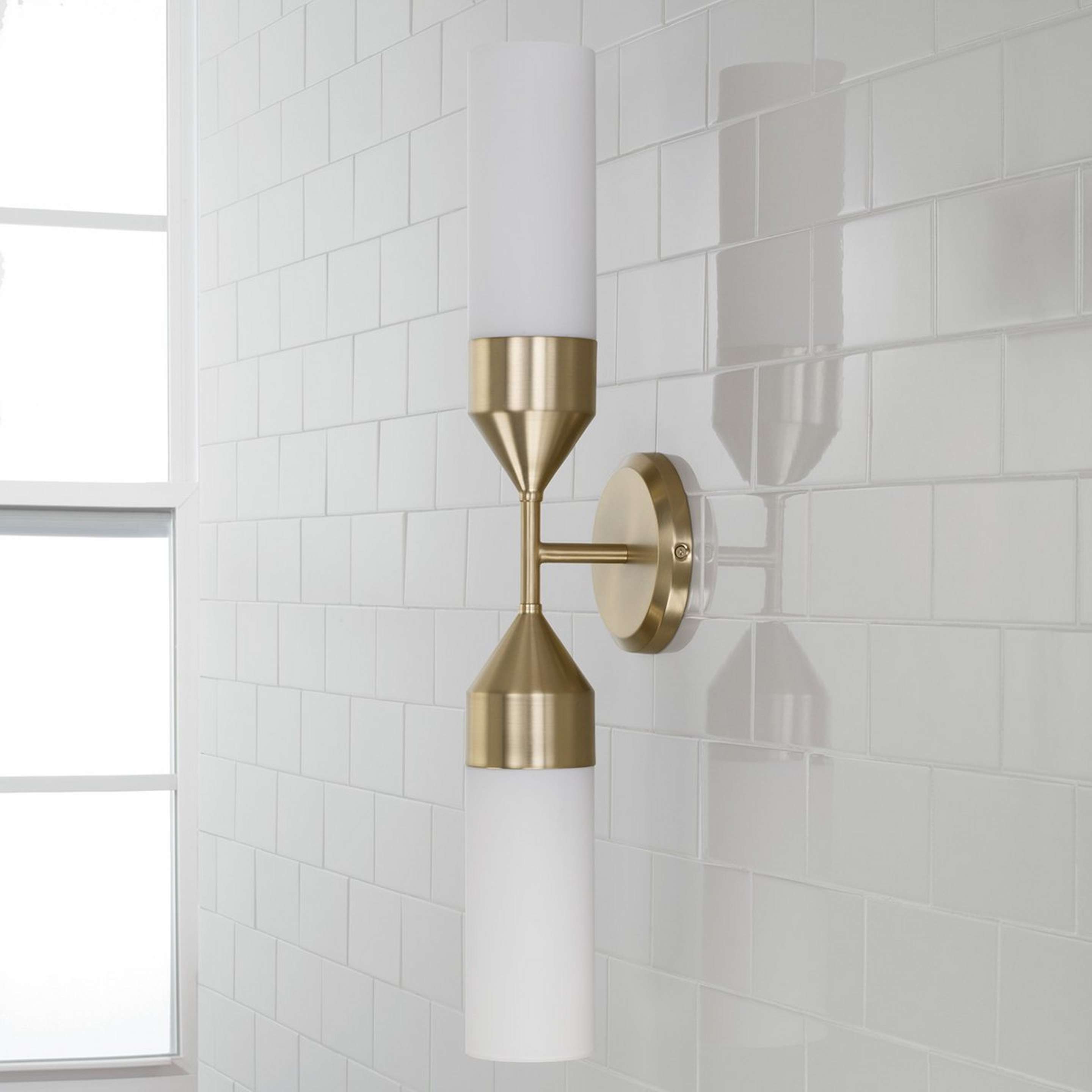 A Reina Bath Sconce with Aged Brass / White Glass color