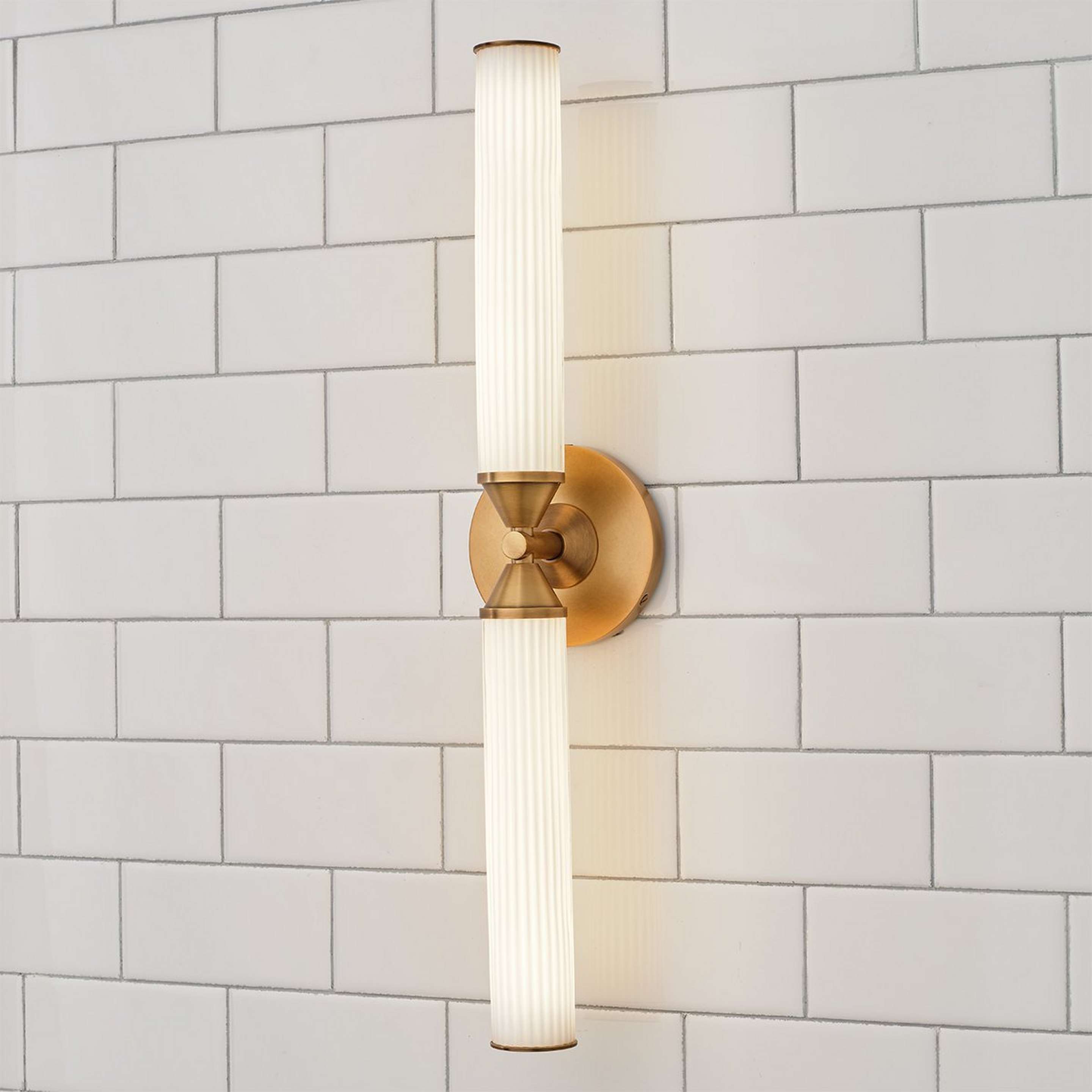 A Faust LED Bath Sconce - 22" with Aged Brass / White Ribbed Glass color