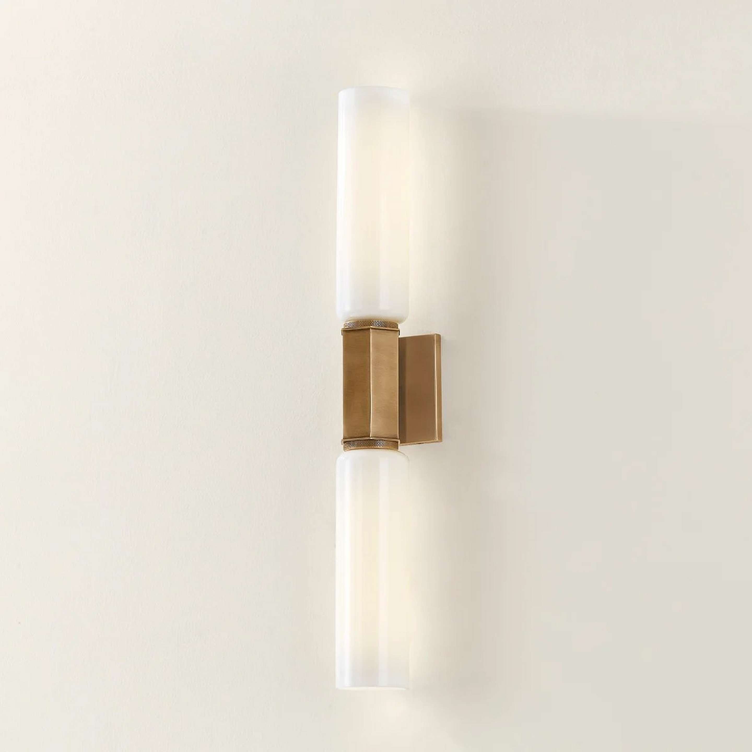 A Radwin Bath Sconce with Brass / White Glass color