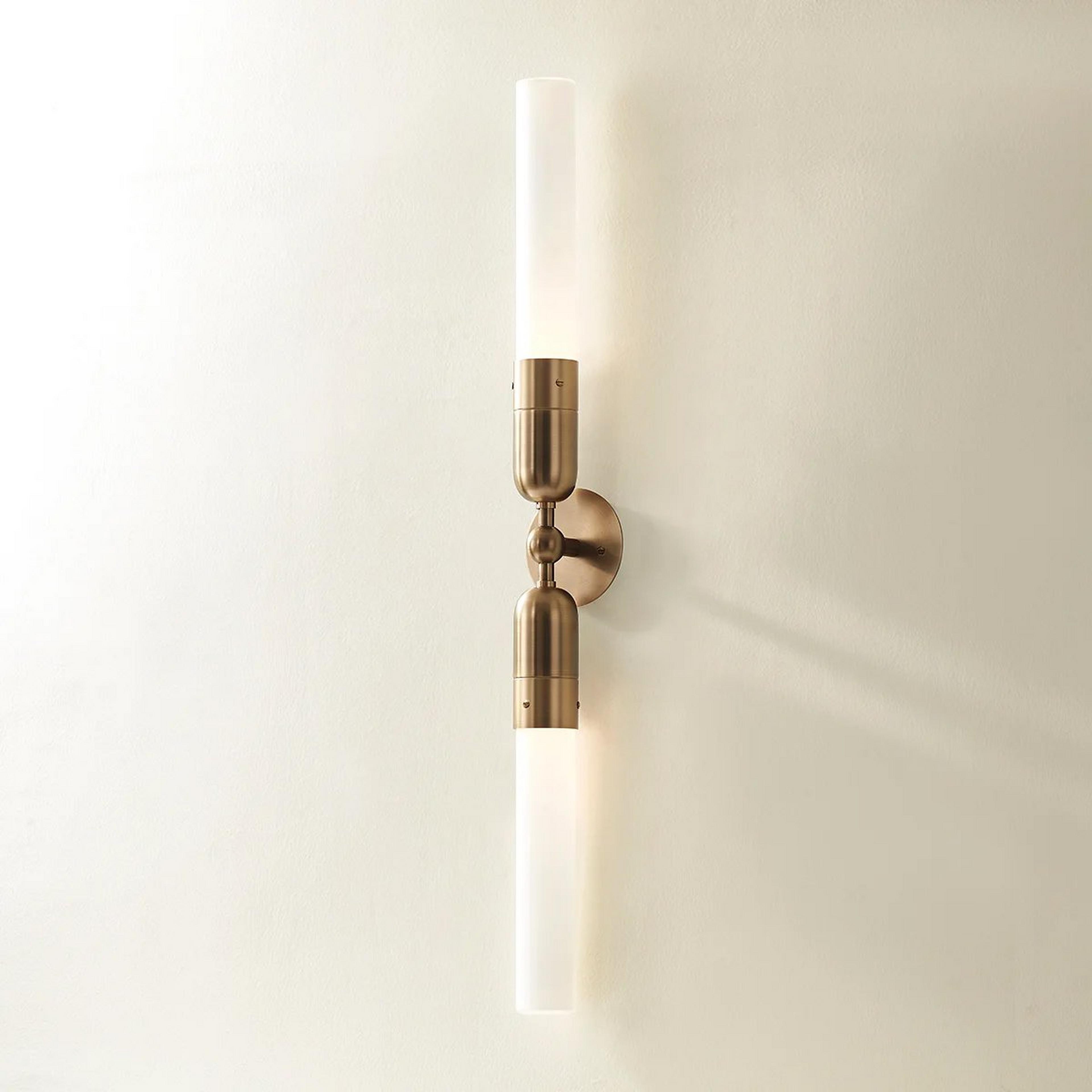 A Wanda Bath Sconce with Brass / White Glass color