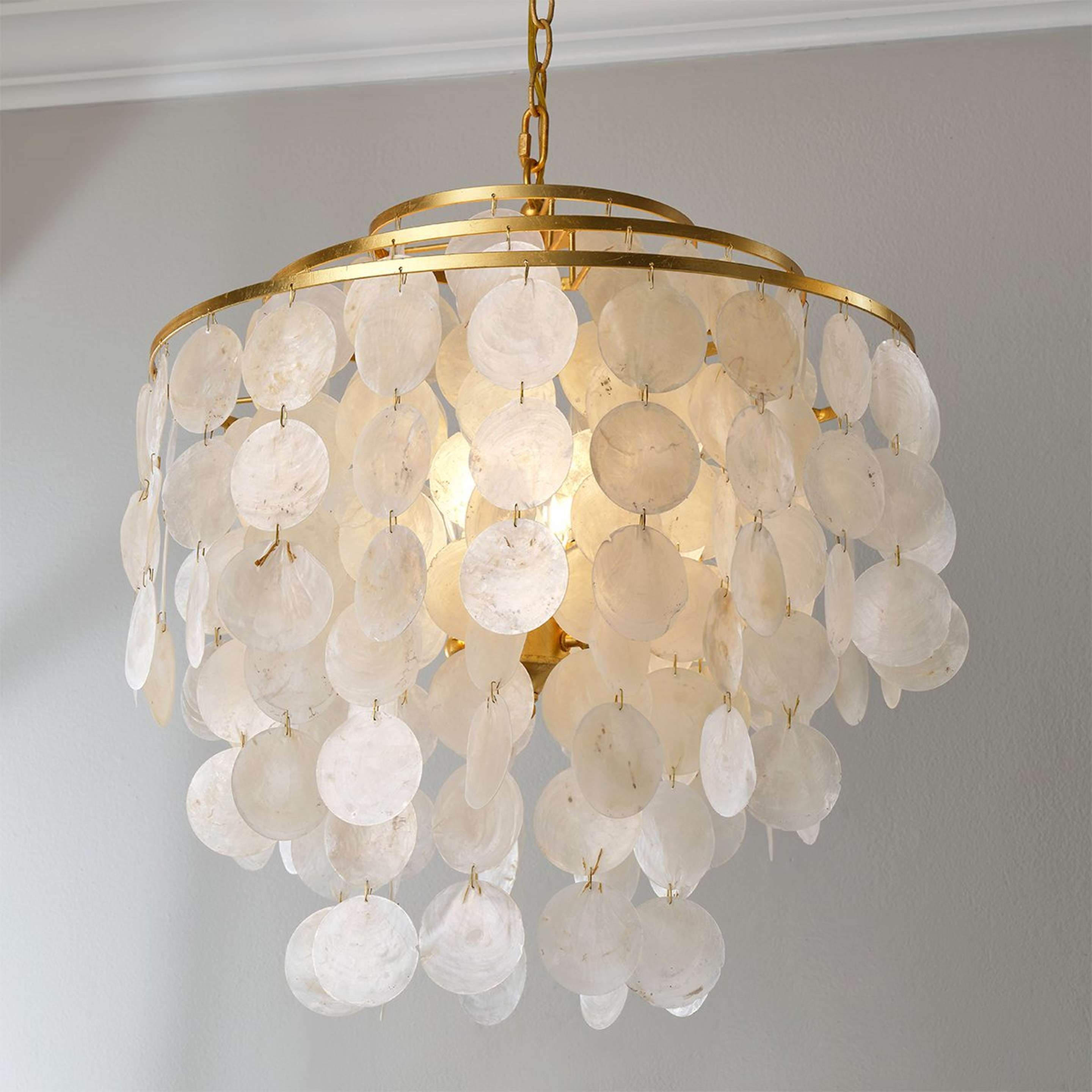 A Young House Love Cascade Capiz Chandelier with Gold Leaf / White Capiz Shells color
