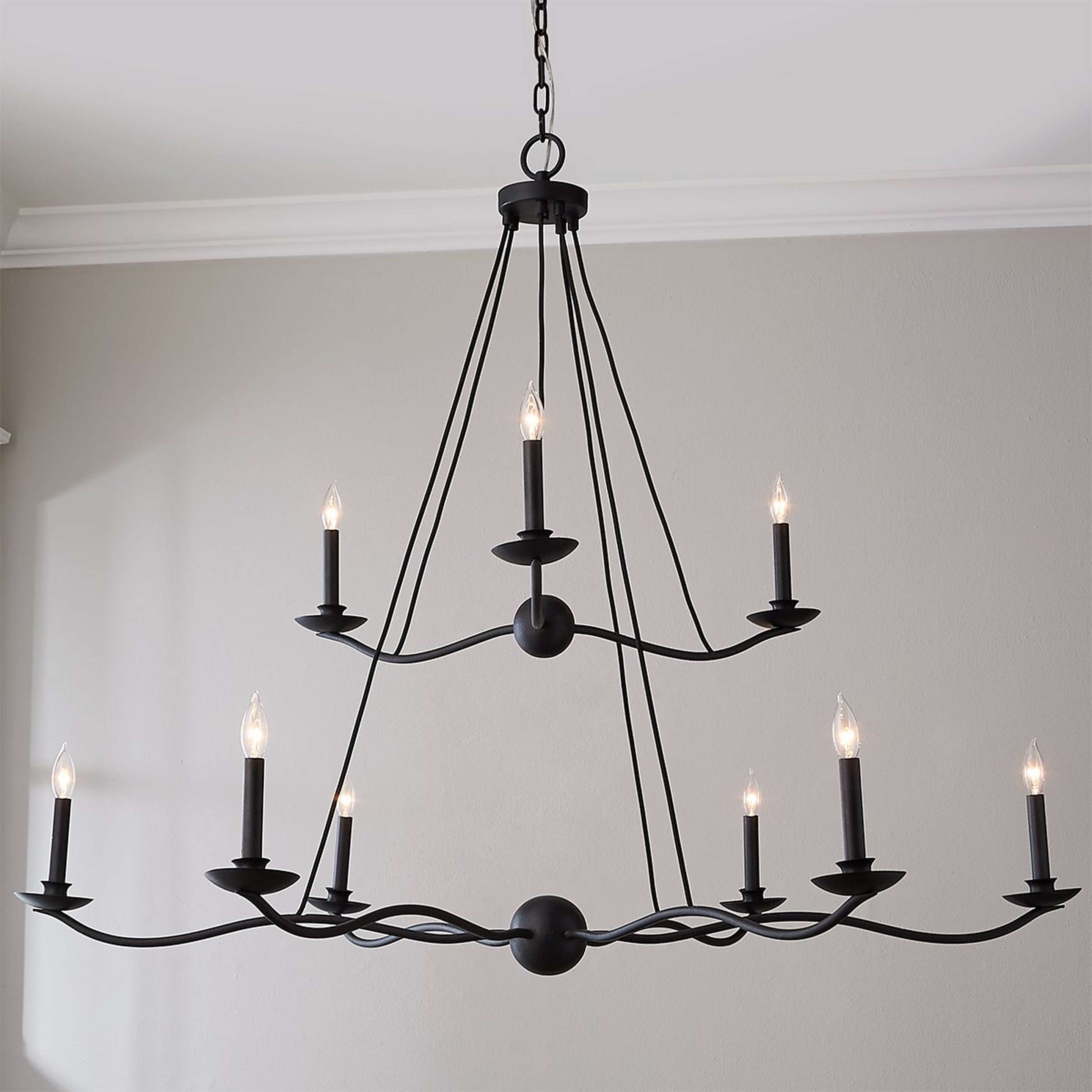 A Transverse Waves Tiered Chandelier with Forged Iron color