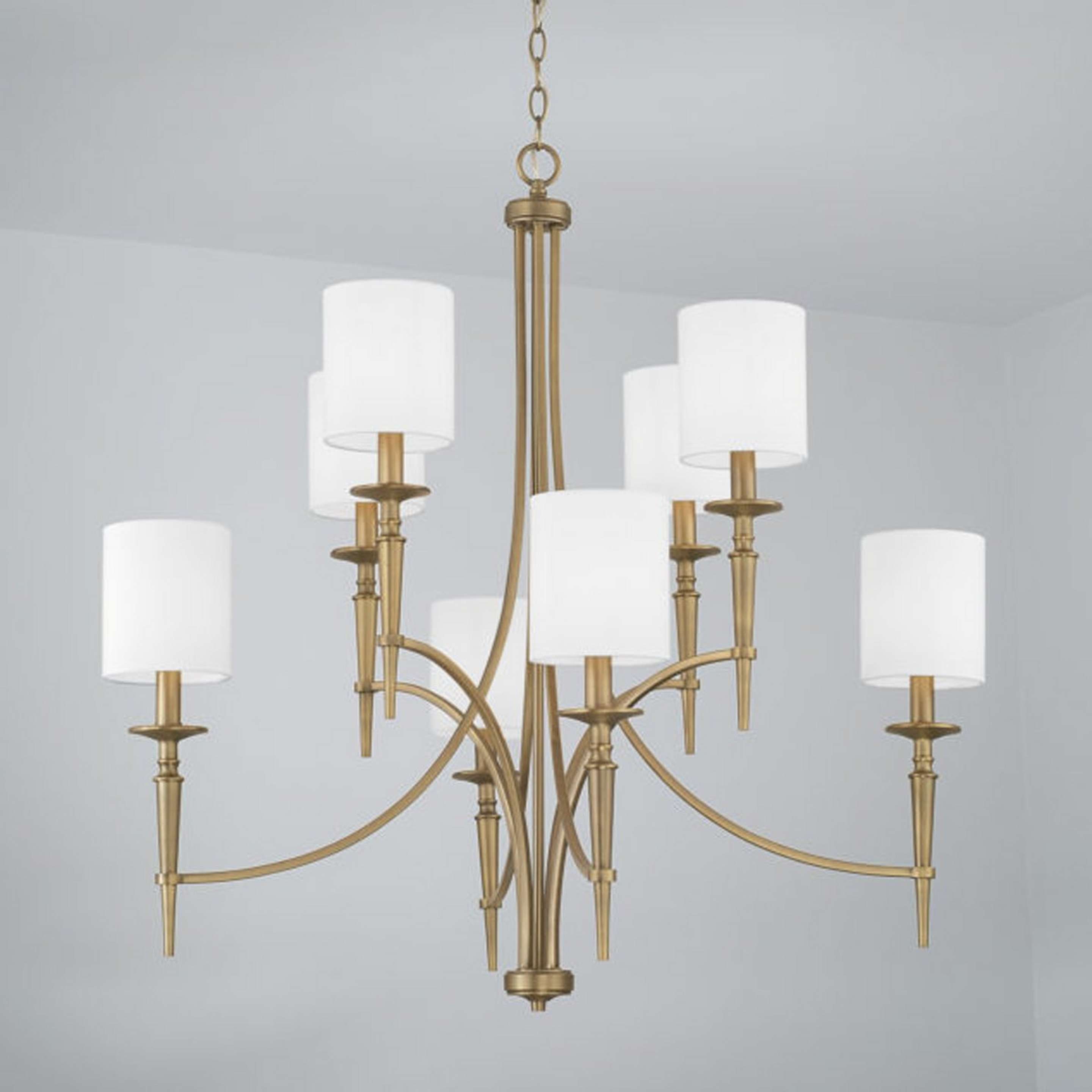 A Bella Tiered Chandelier with Aged Brass color