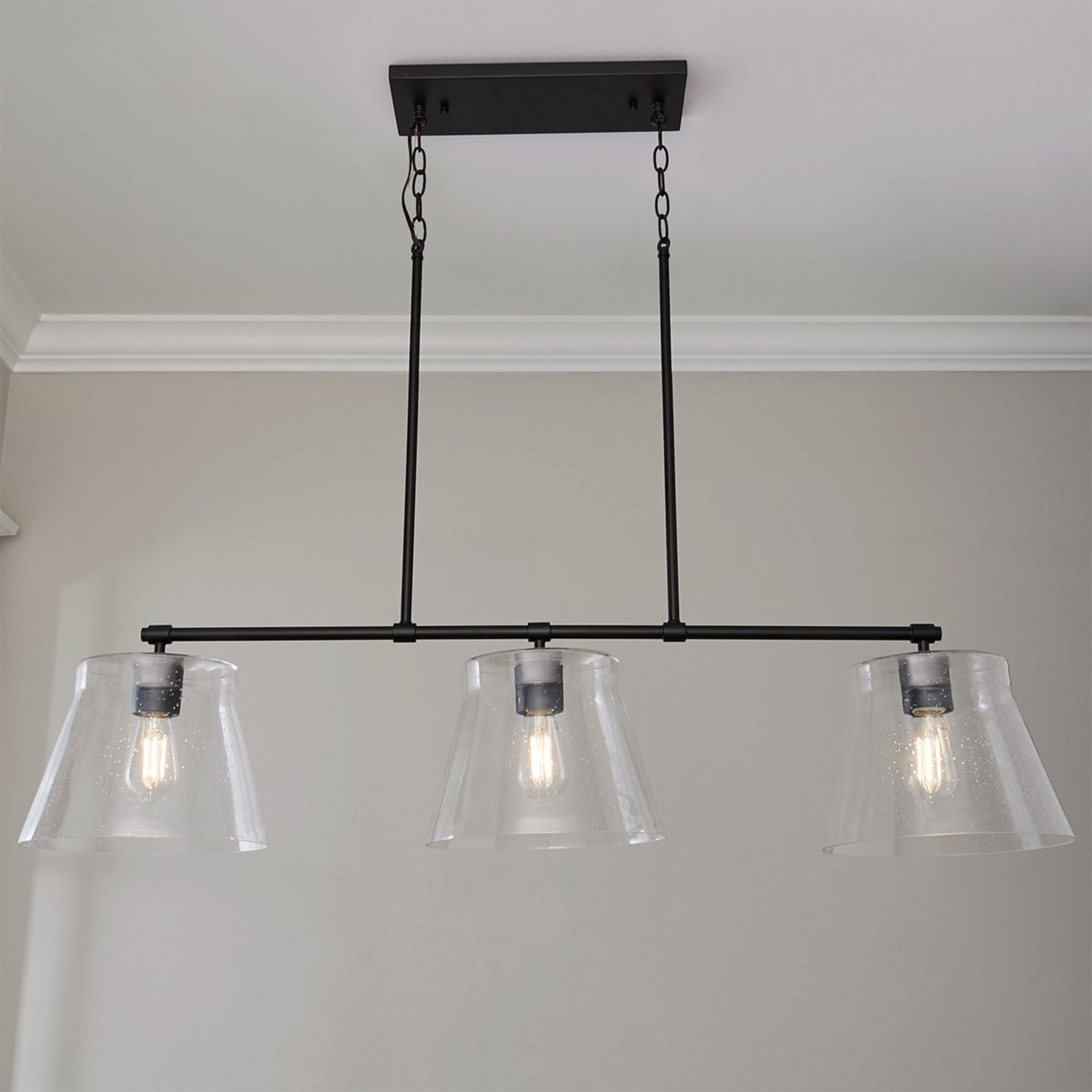 A Davalyn Island Chandelier with Matte Black / Seeded Glass color