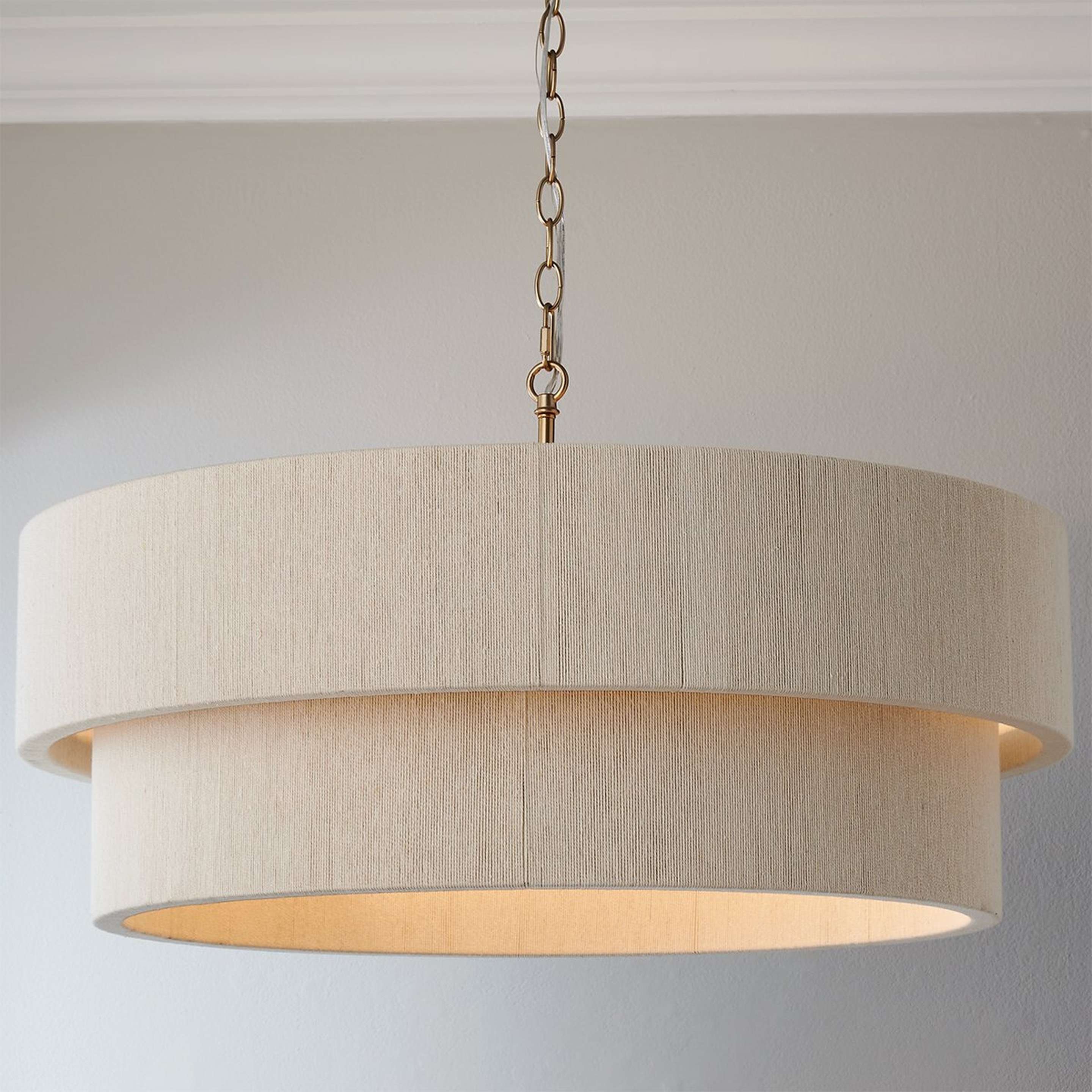 A Kalini Double Drum Chandelier with Matte Brass / Bleached Natural Rope color