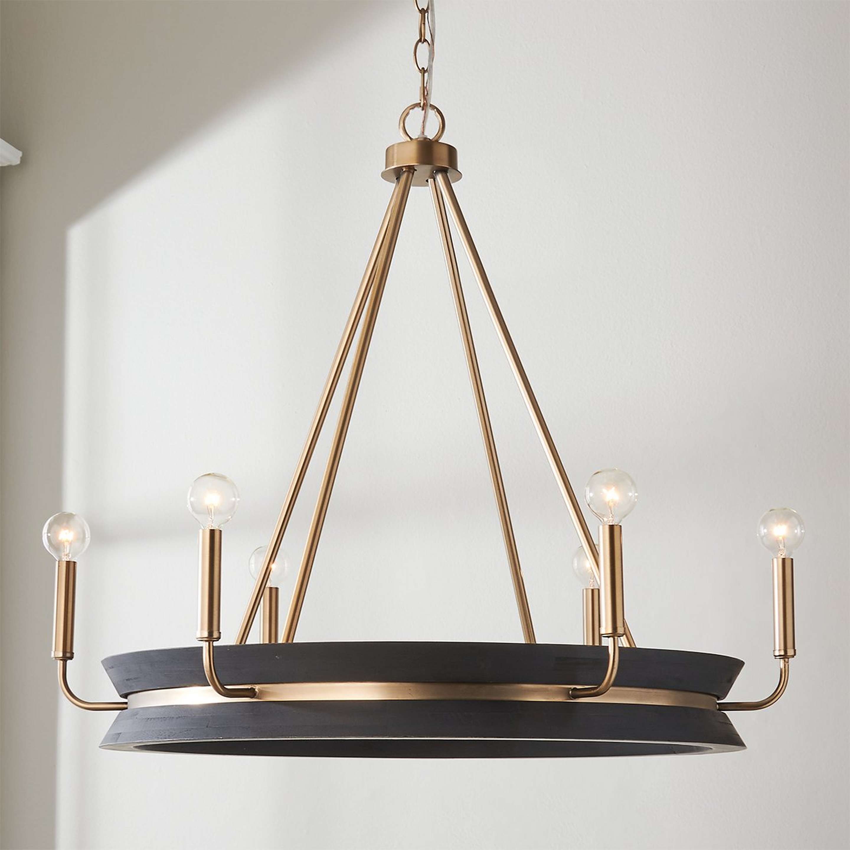 A Tajani Chandelier with Matte Brass / Black Mango Wood color