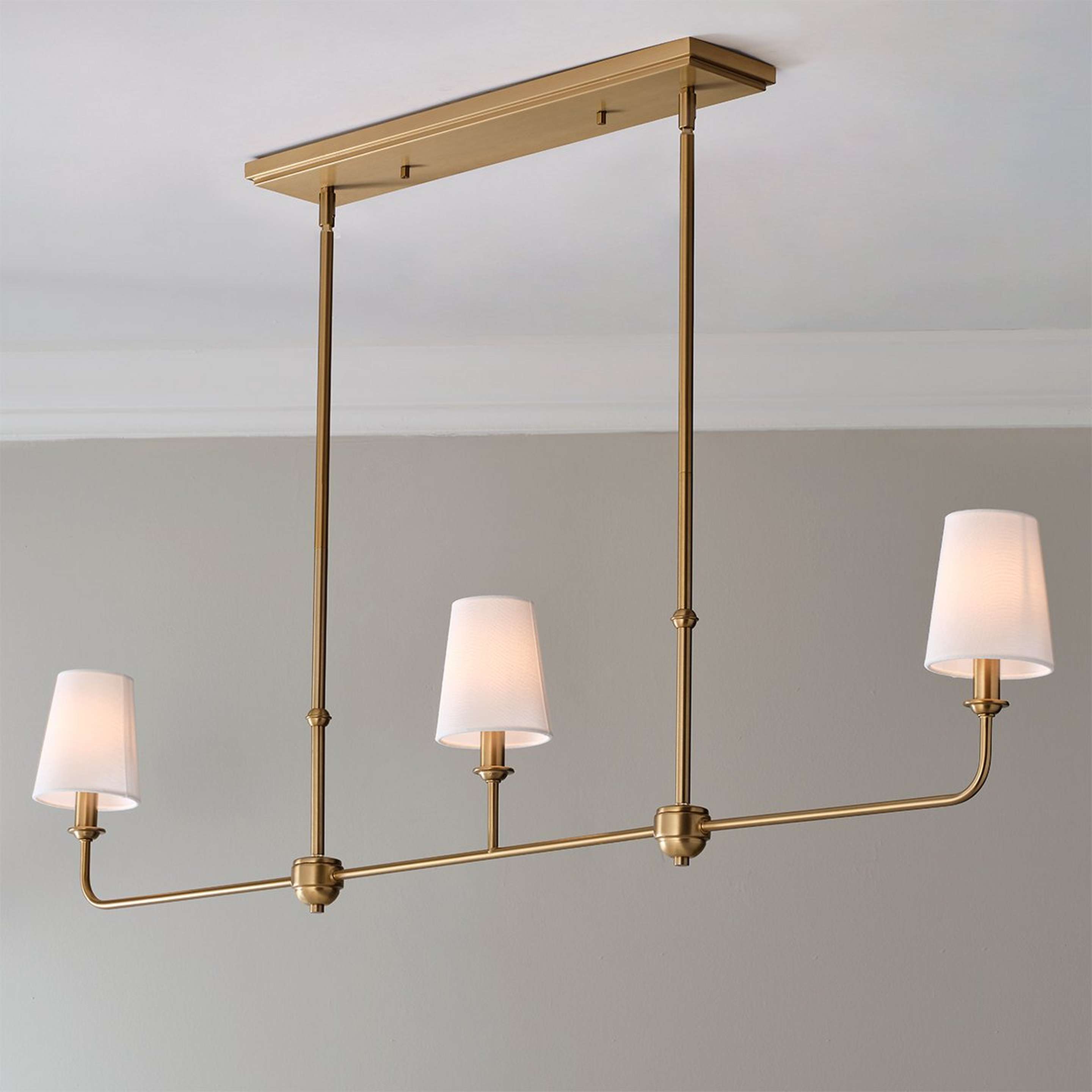 A Willemina Linear Chandelier with Aged Brass color