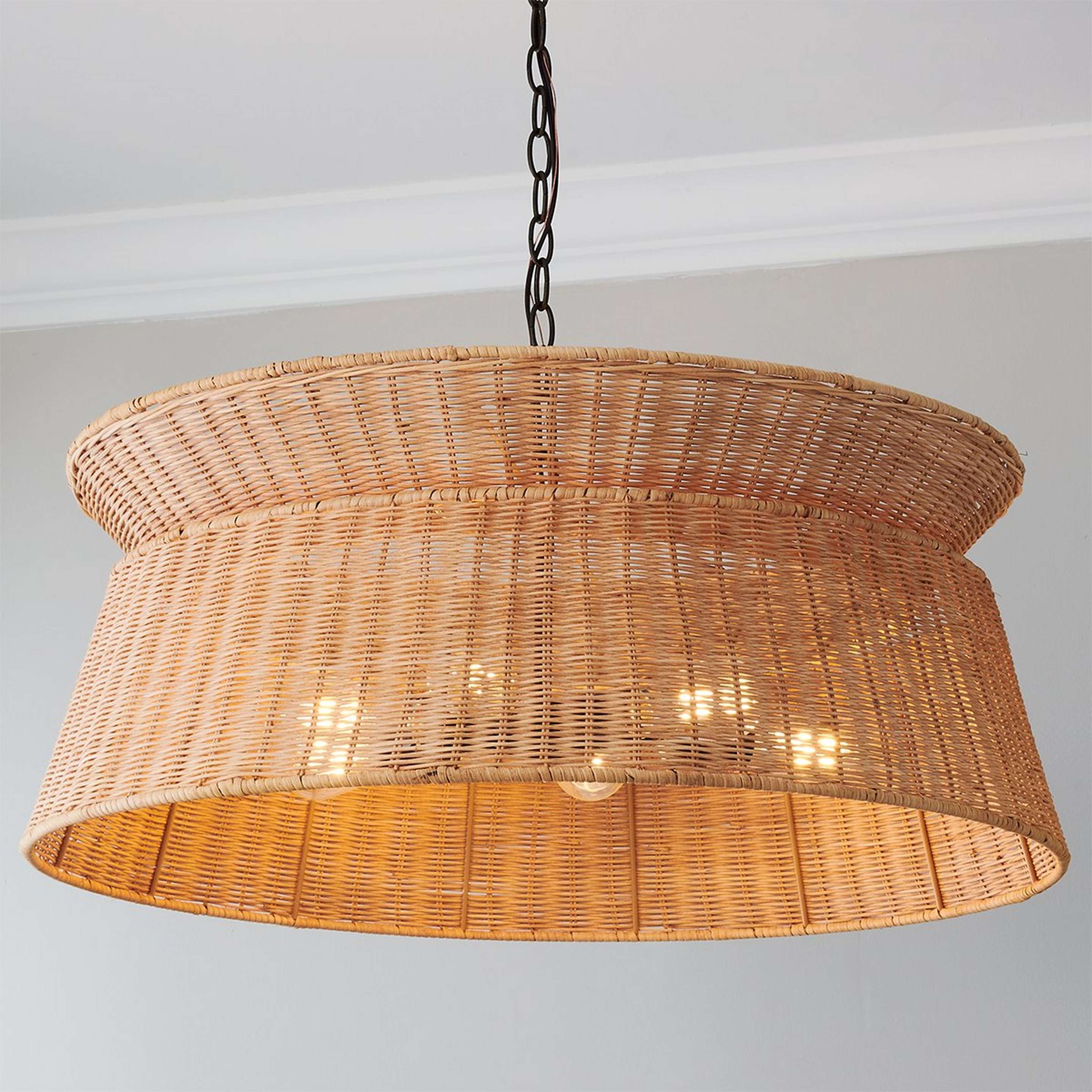 A Respiro Chandelier with Dark Bronze / Natural Rattan color
