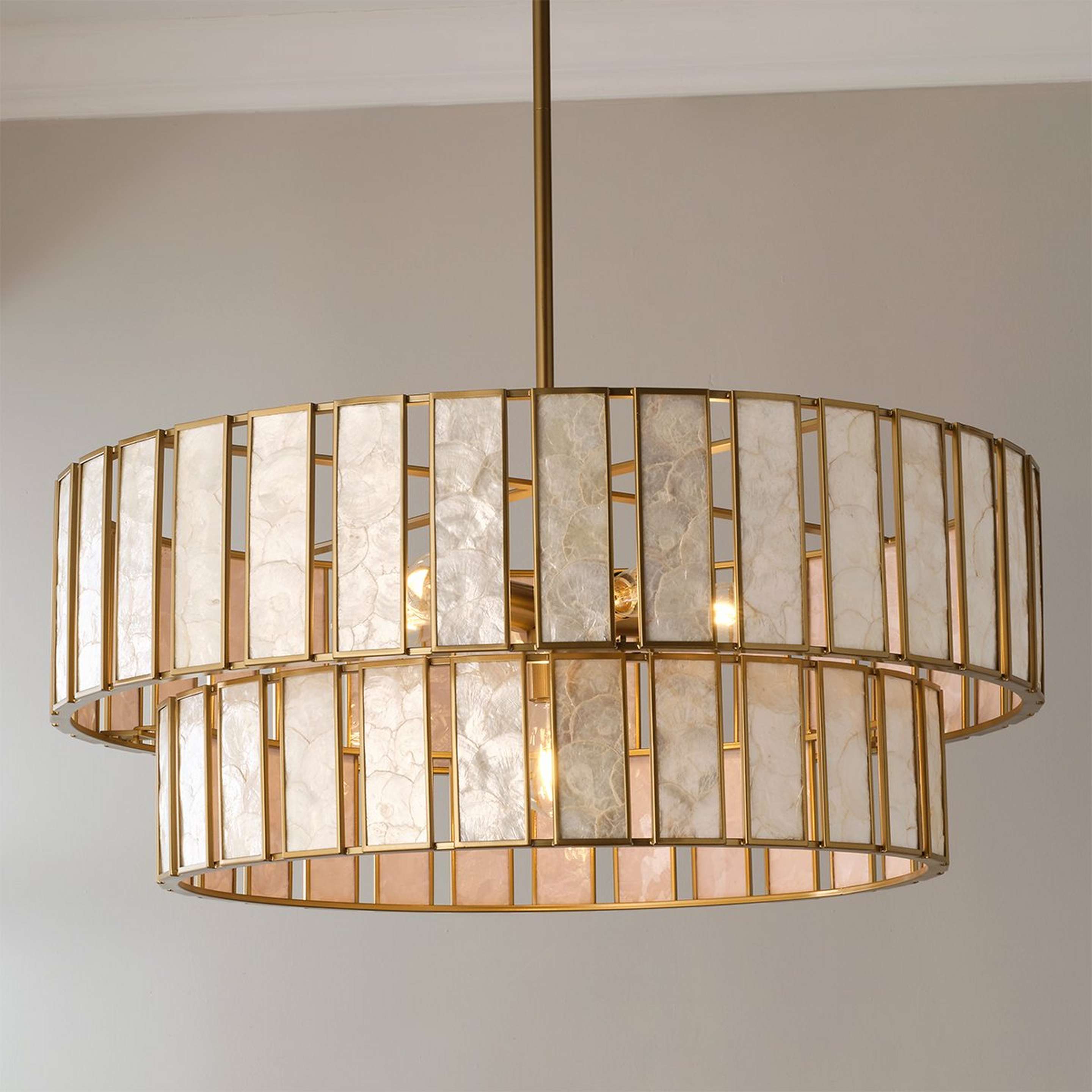 A Zoetrope Tiered Chandelier - 6 Light with Natural Brass / Capiz Shell color
