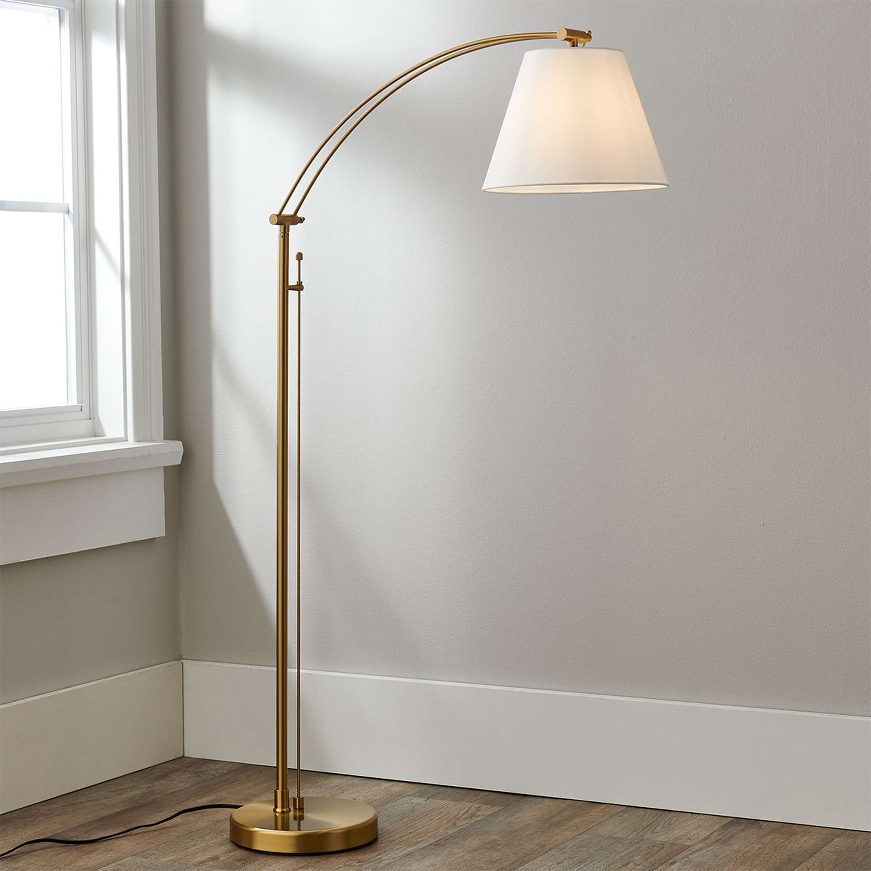 A Arc Baudelair Floor Lamp with Aged Brass color