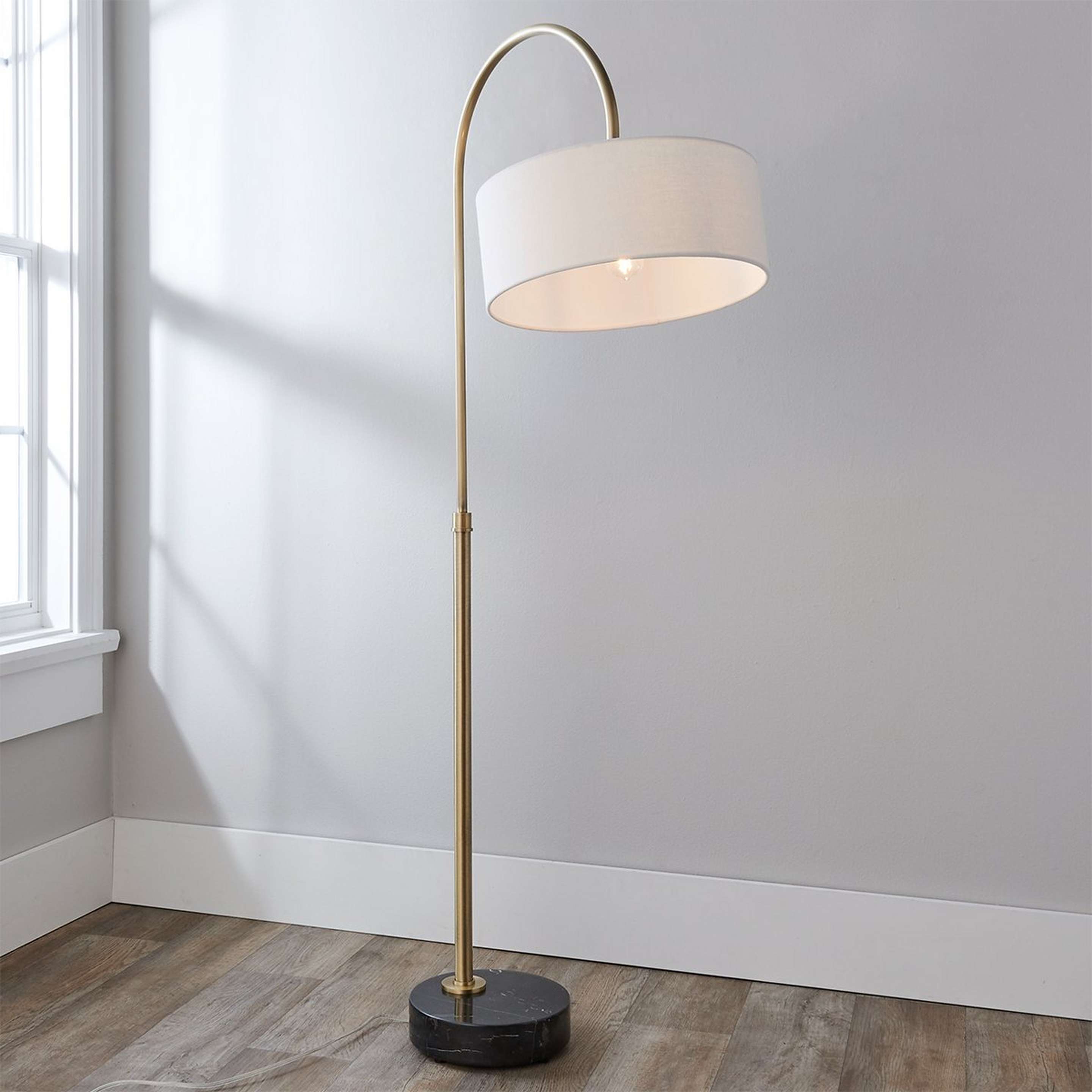 A Luvina Adjustable Arc Floor Lamp with Brushed Brass / Black Marble color