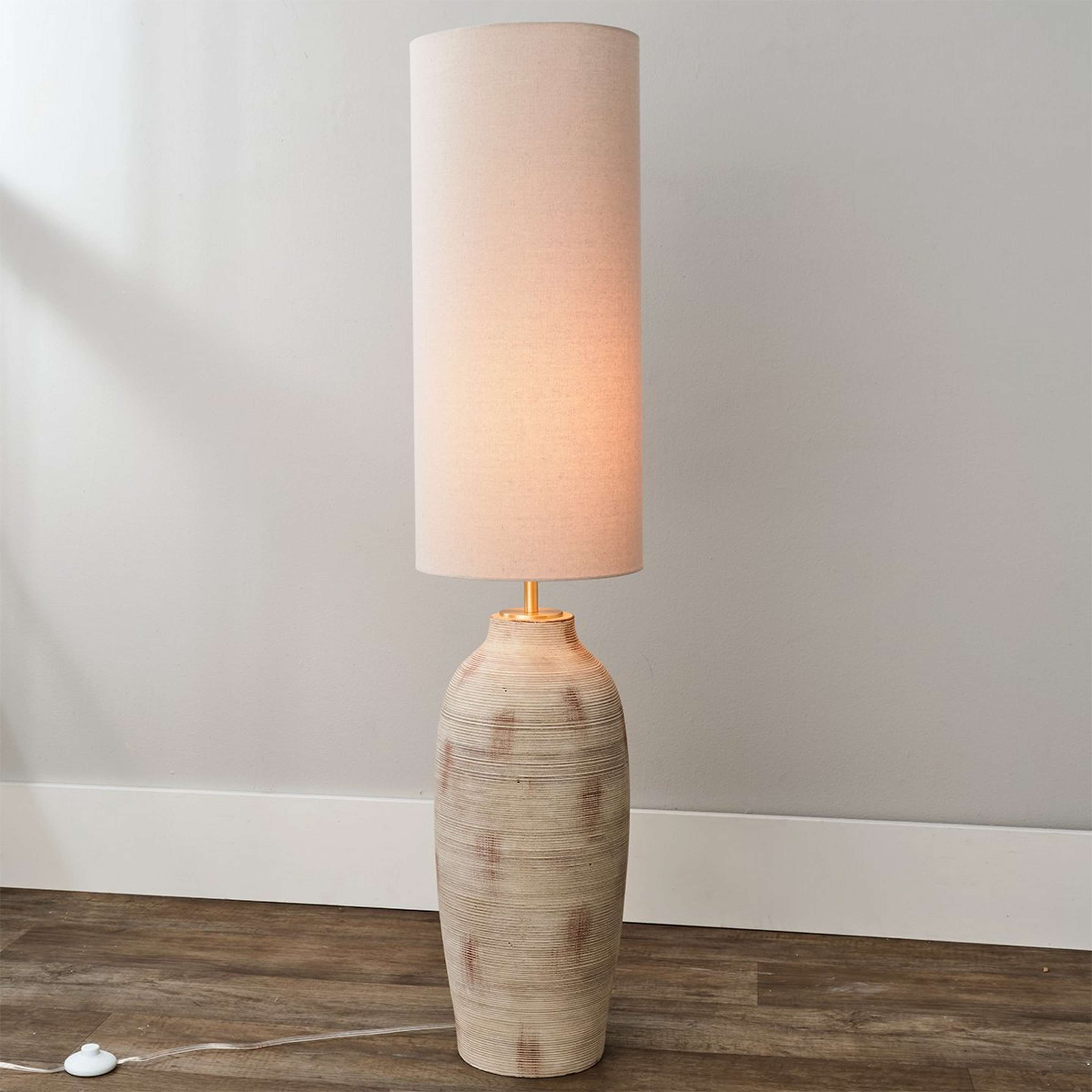 A Rafaela Floor Lamp with Rustic Cream / Wheat Linen color