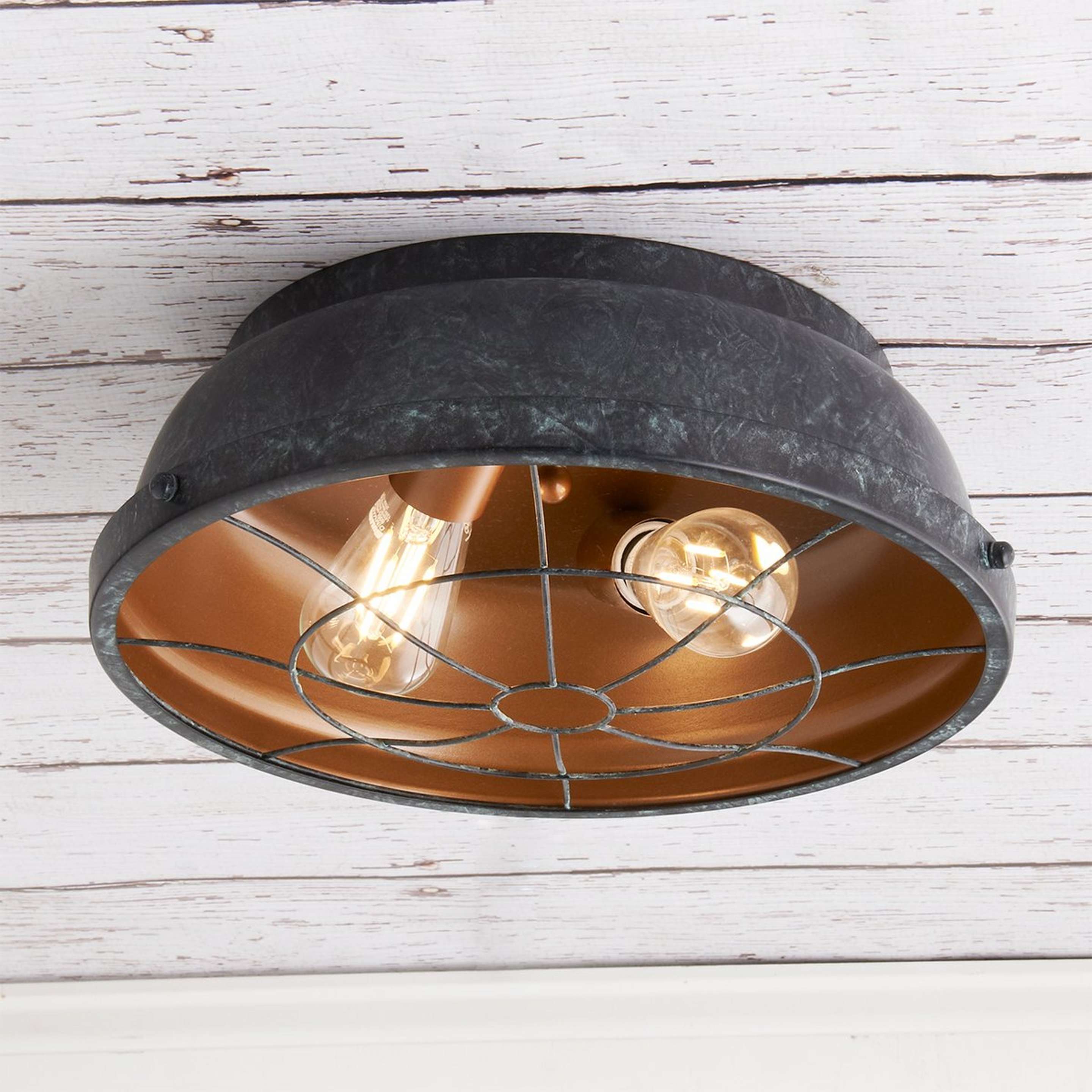 A Weathered Industrial Caged Ceiling Light with Black Patina / Copper color