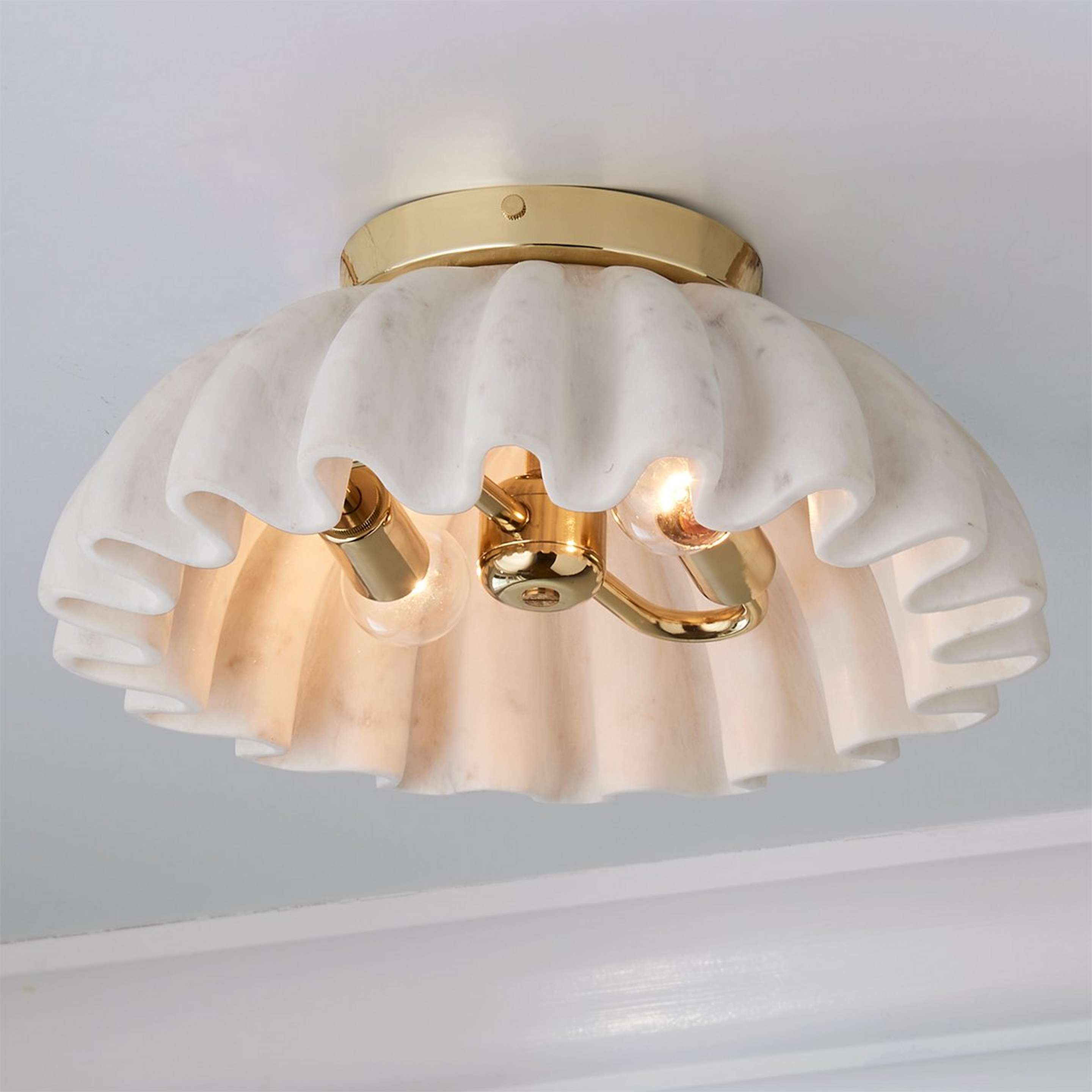 A Carved Marble Ruffle Ceiling Light with Polished Brass / White Marble color