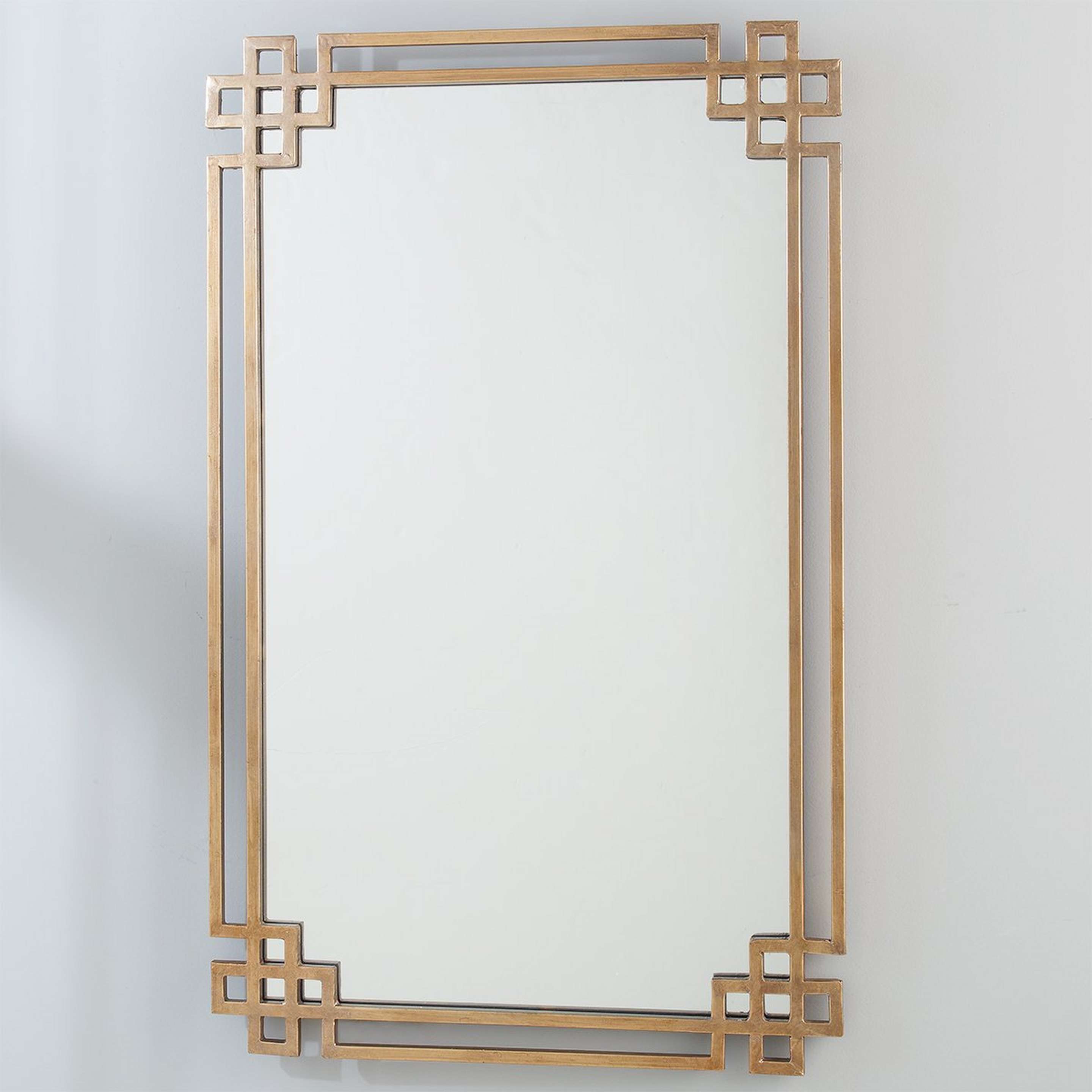 A Golden Ornate Metal Mirror with Antique Gold color