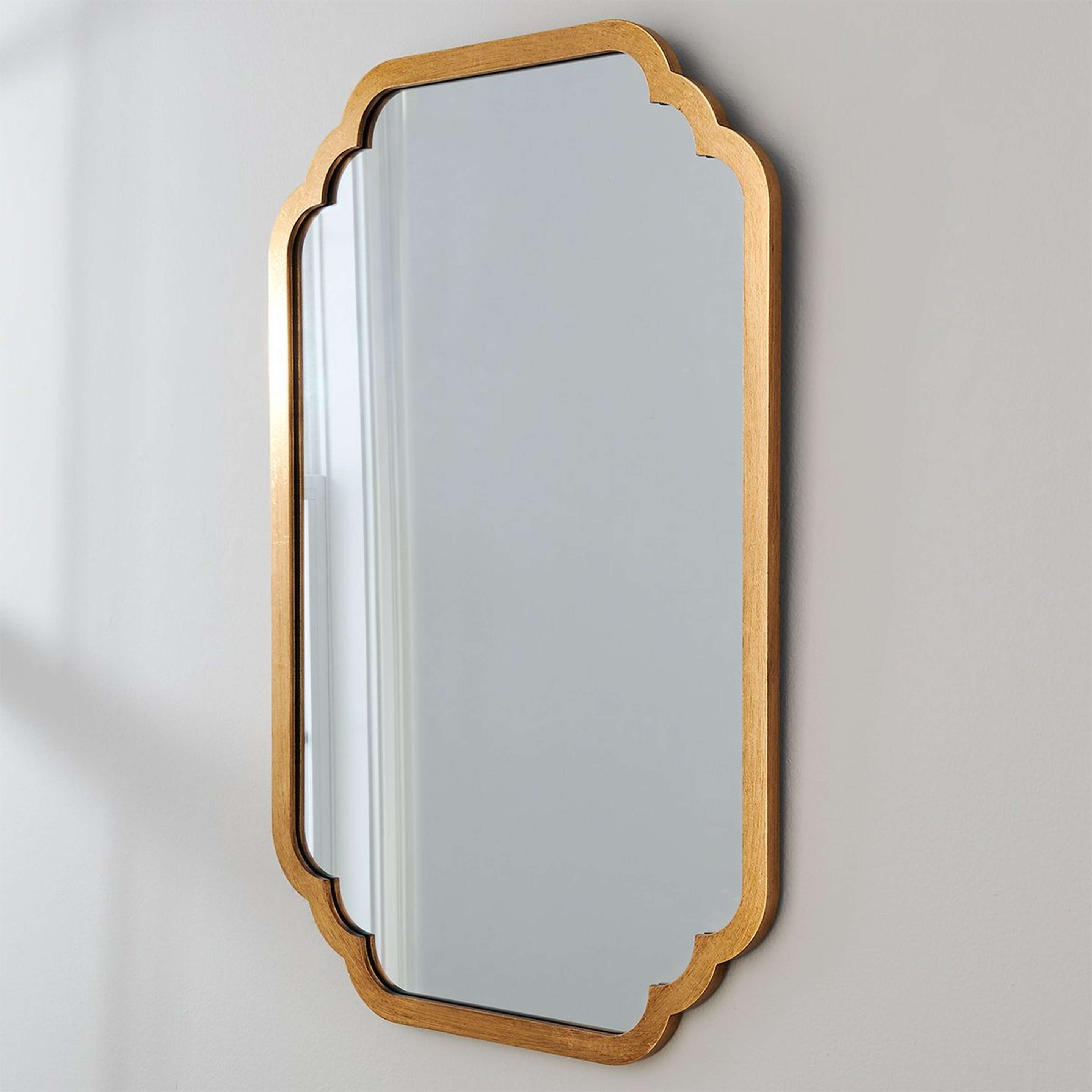 A Scalloped Edge Mirror with Gold Leaf color