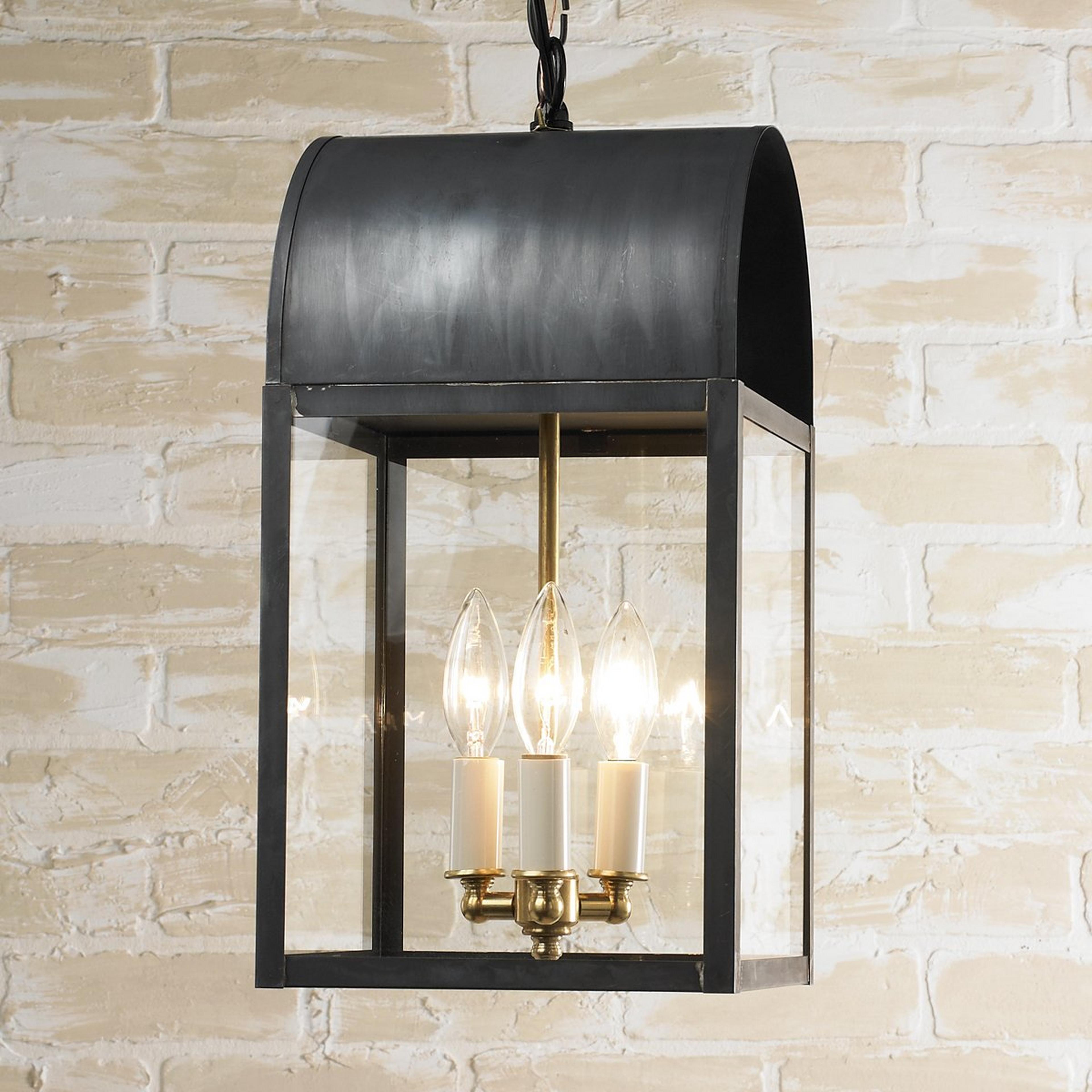 A Colonial Metalcrafts Arched Outdoor Lantern with Darkened Copper / Clear Glass color