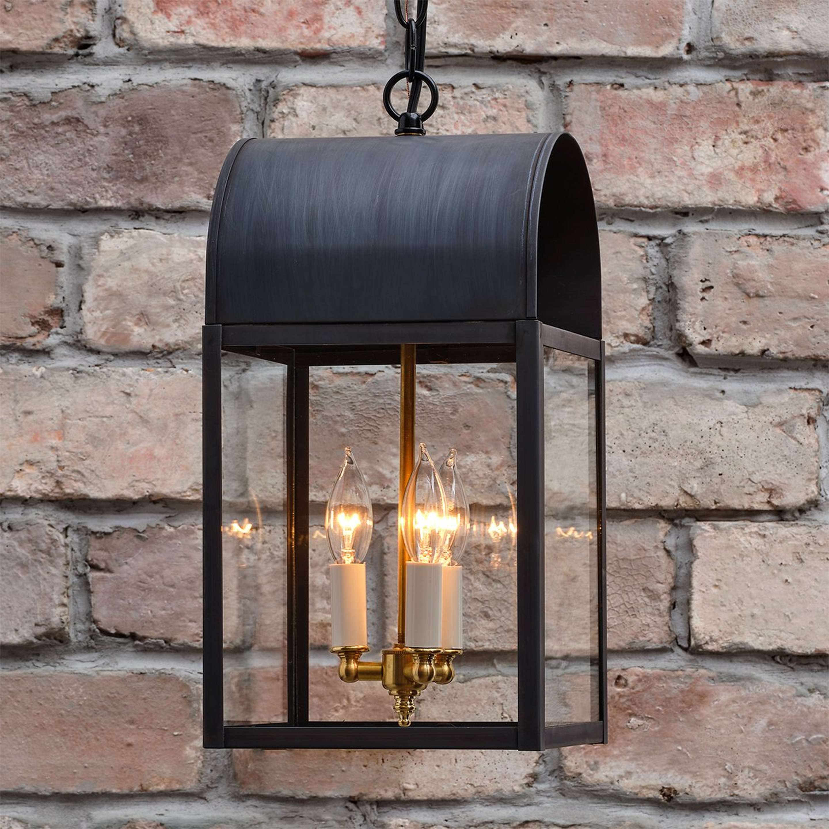 A Colonial Metalcrafts Arched Outdoor Lantern with Darkened Copper / Clear Glass color