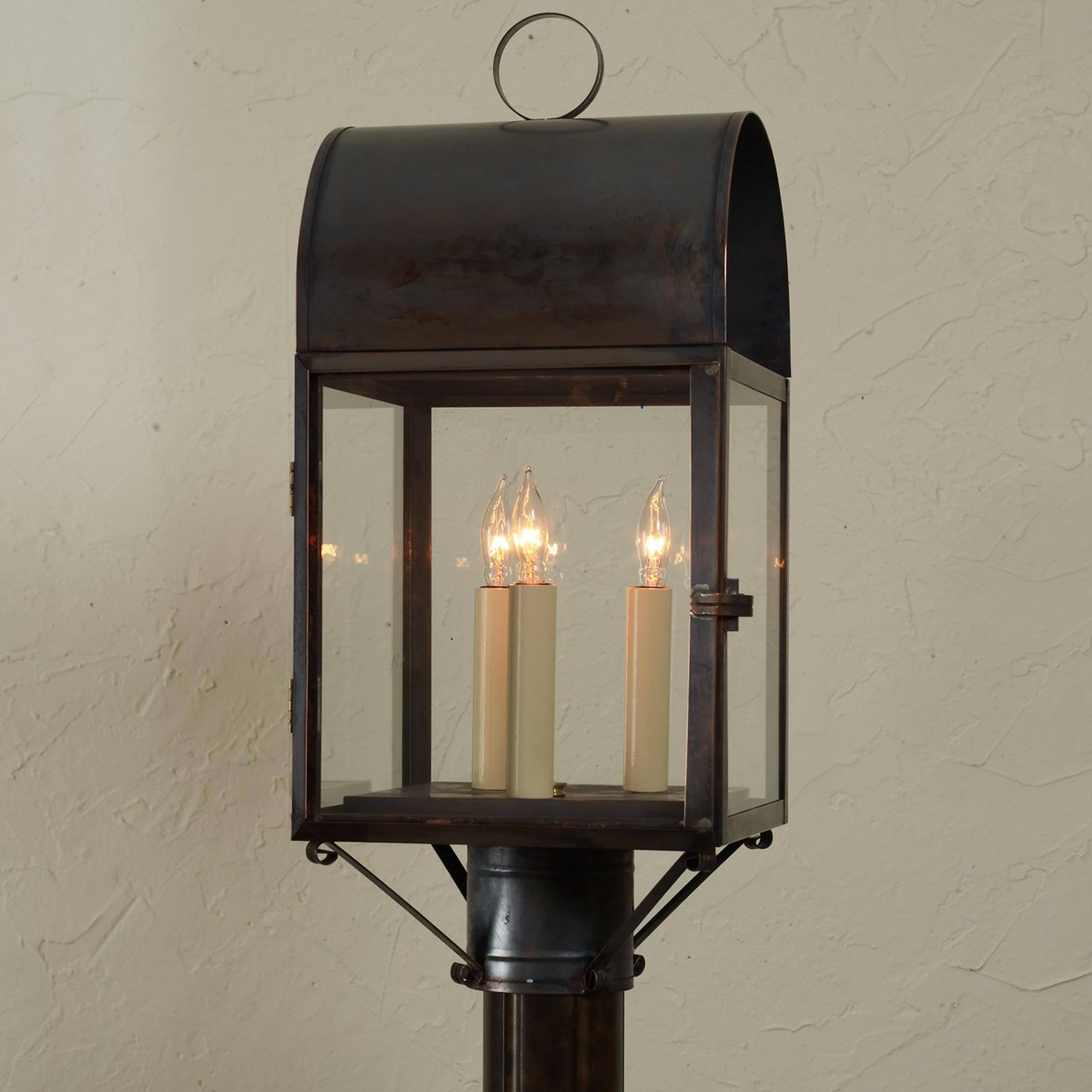 A Colonial Metalcrafts Arched Outdoor Post Light with Darkened Copper / Clear Glass color