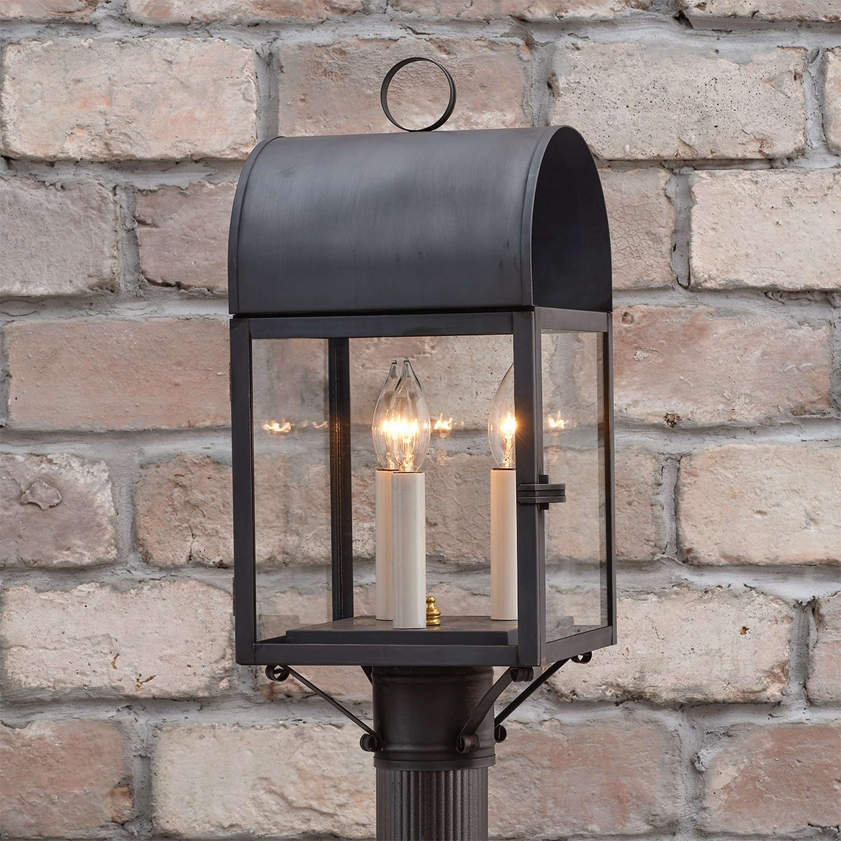 A Colonial Metalcrafts Arched Outdoor Post Light with Darkened Copper / Clear Glass color
