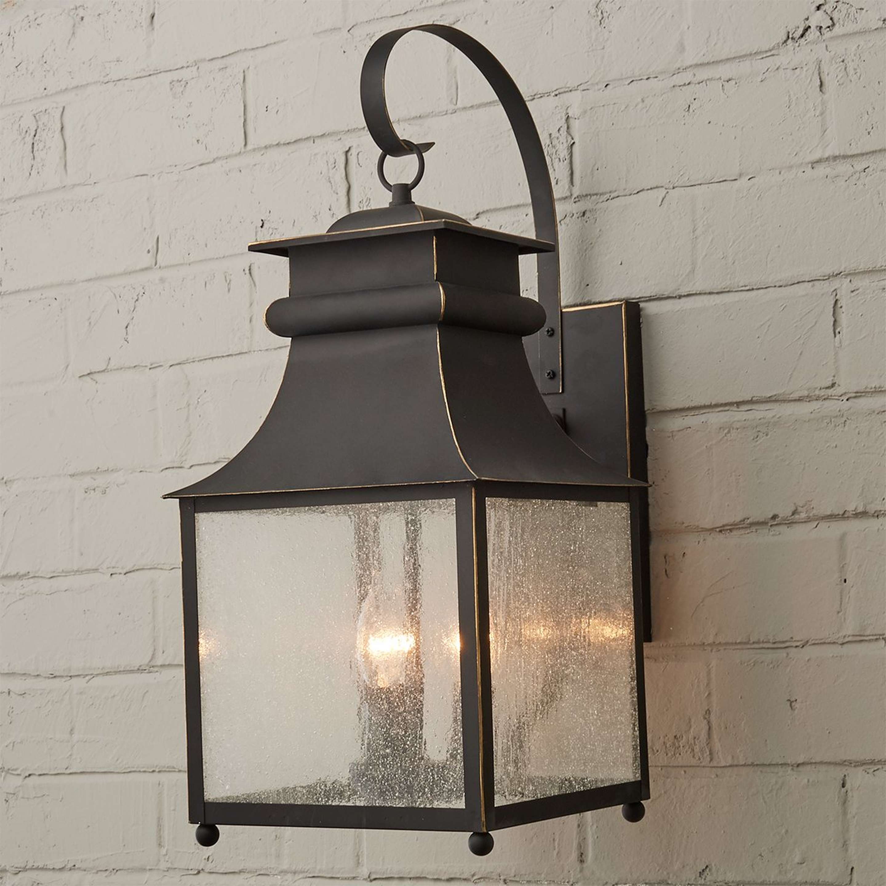 A Homesteader Seeded Glass Outdoor Sconce - 3 Light with Bronze color