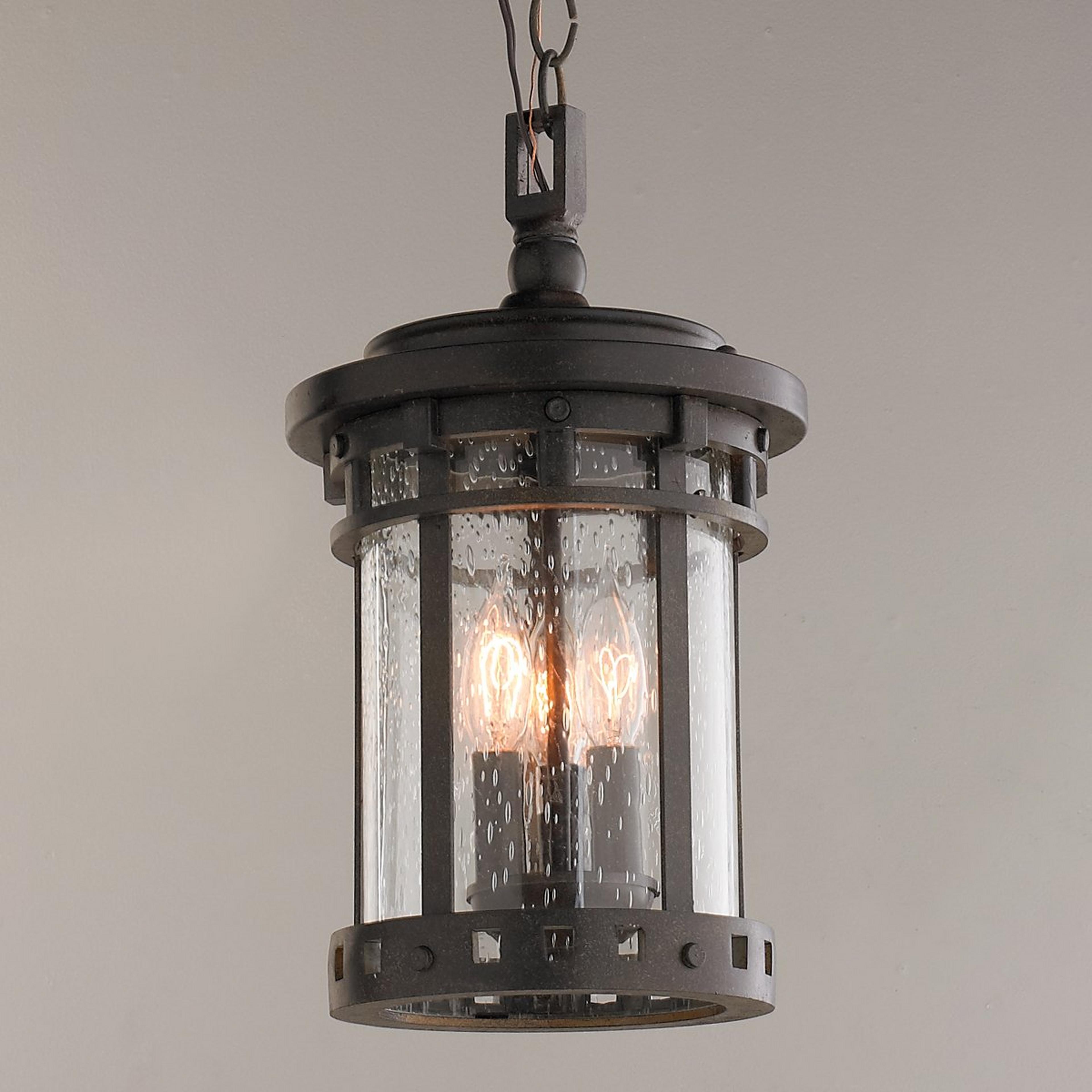 A Seeded Glass Prairie Style Outdoor Lantern with Weathered Bronze color