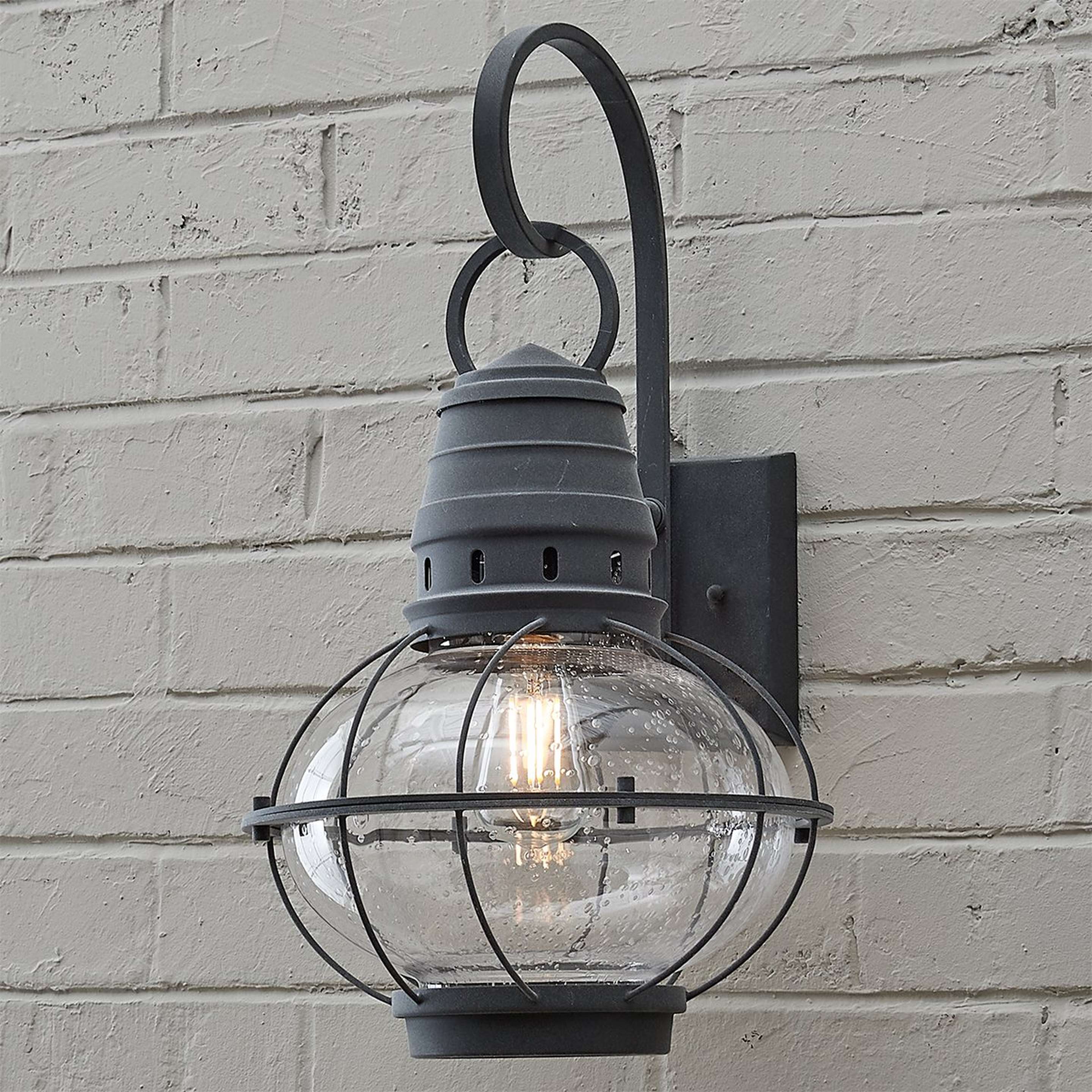 A Seeded Glass Globe Outdoor Sconce - Large with Weathered Zinc color
