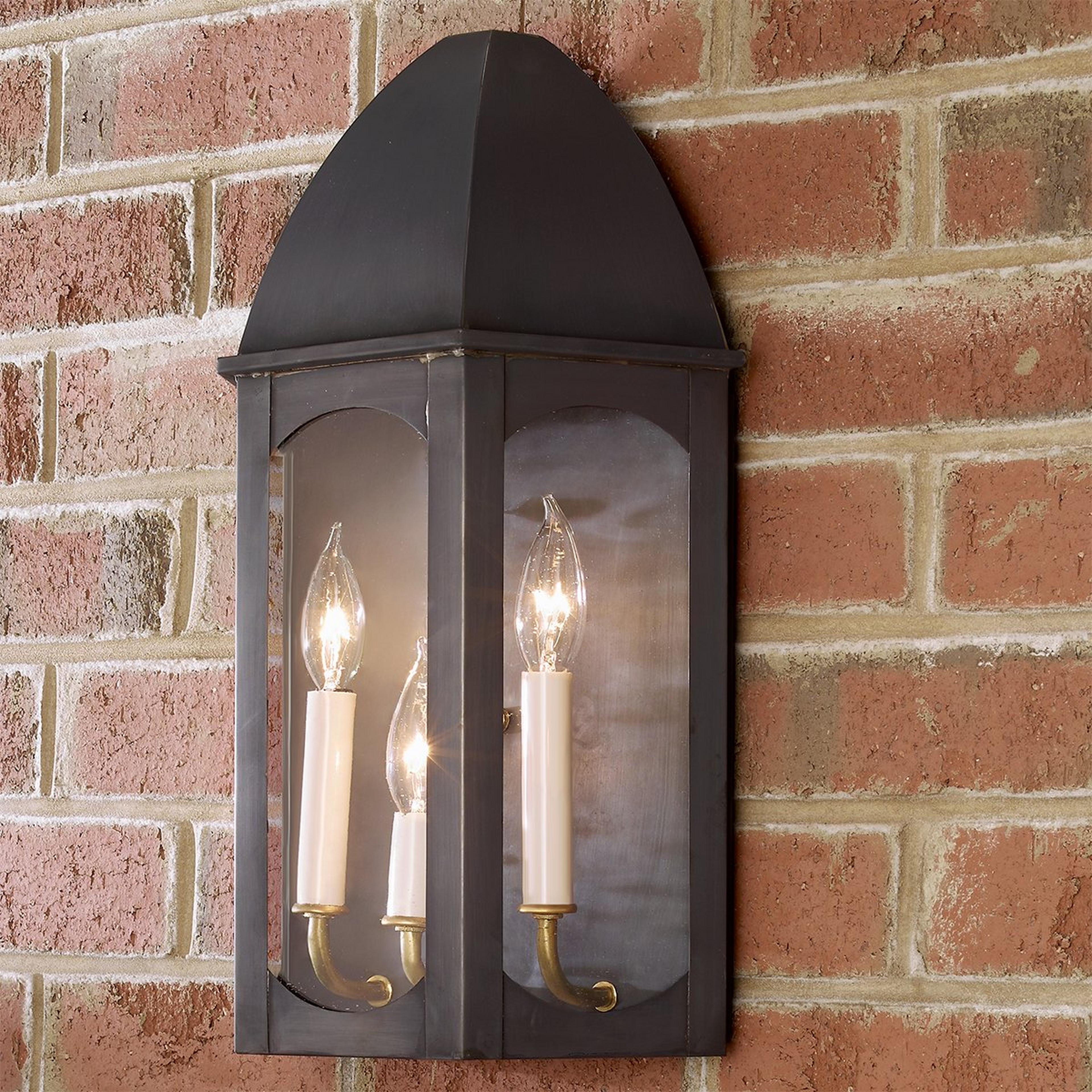 A Florence Outdoor Wall Light with Darkened Copper / Clear Glass color