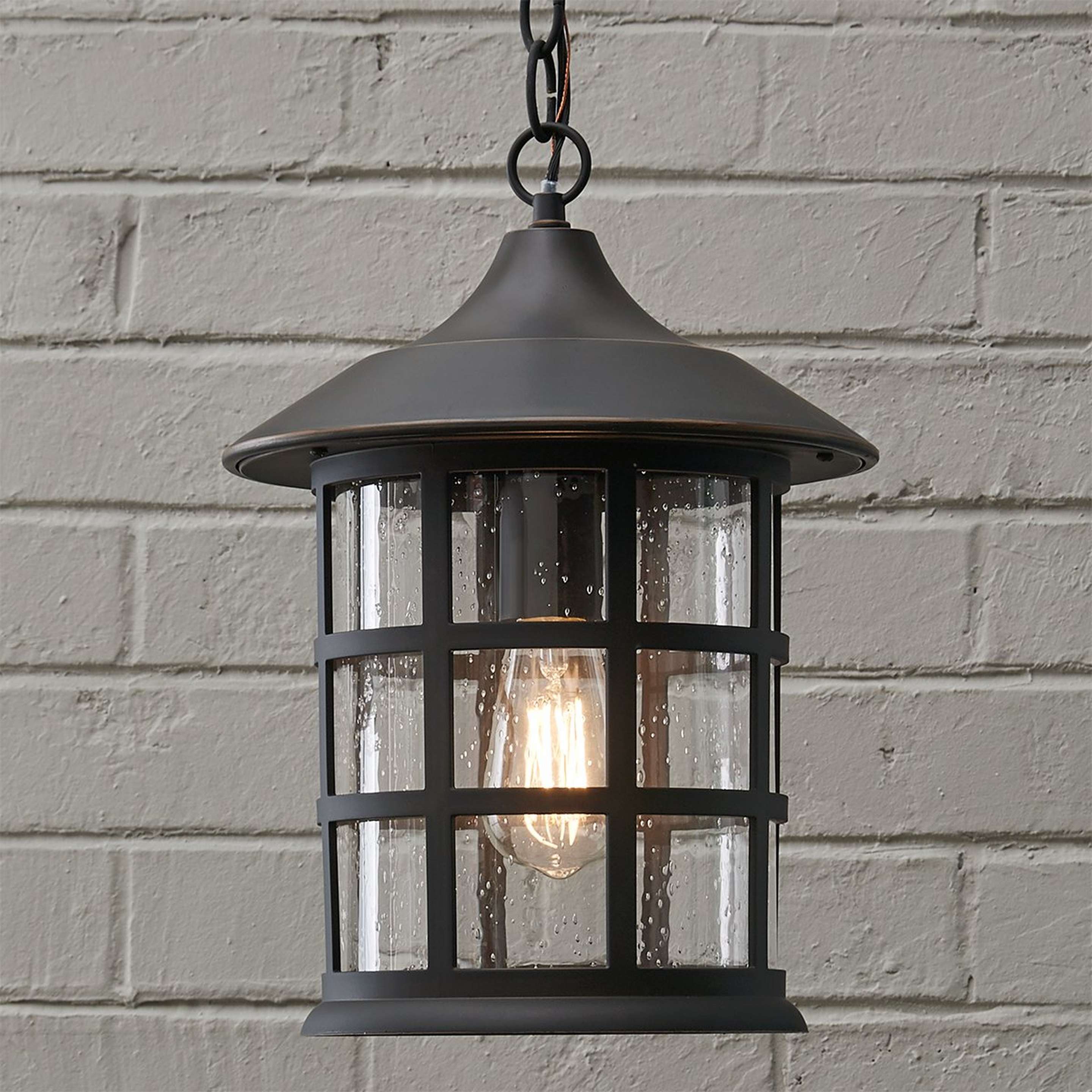 A Bar Harbor Hanging Outdoor Lantern with Oil Rubbed Bronze / Seedy Glass color