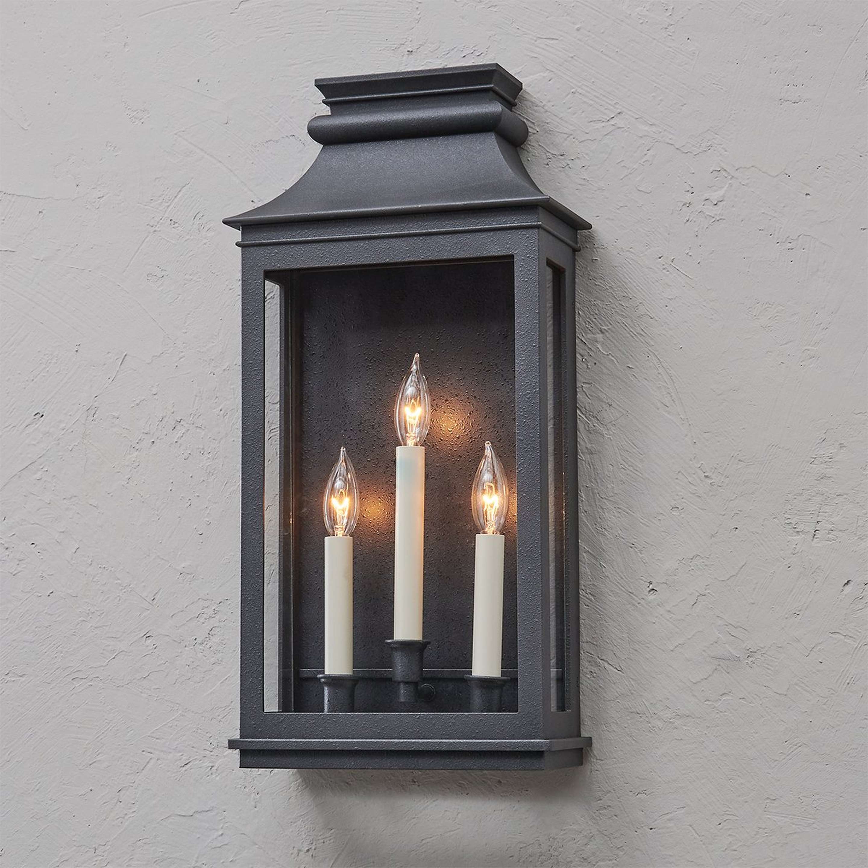 A Zigmund Outdoor Sconce - 3 Light with Black / Clear Glass color