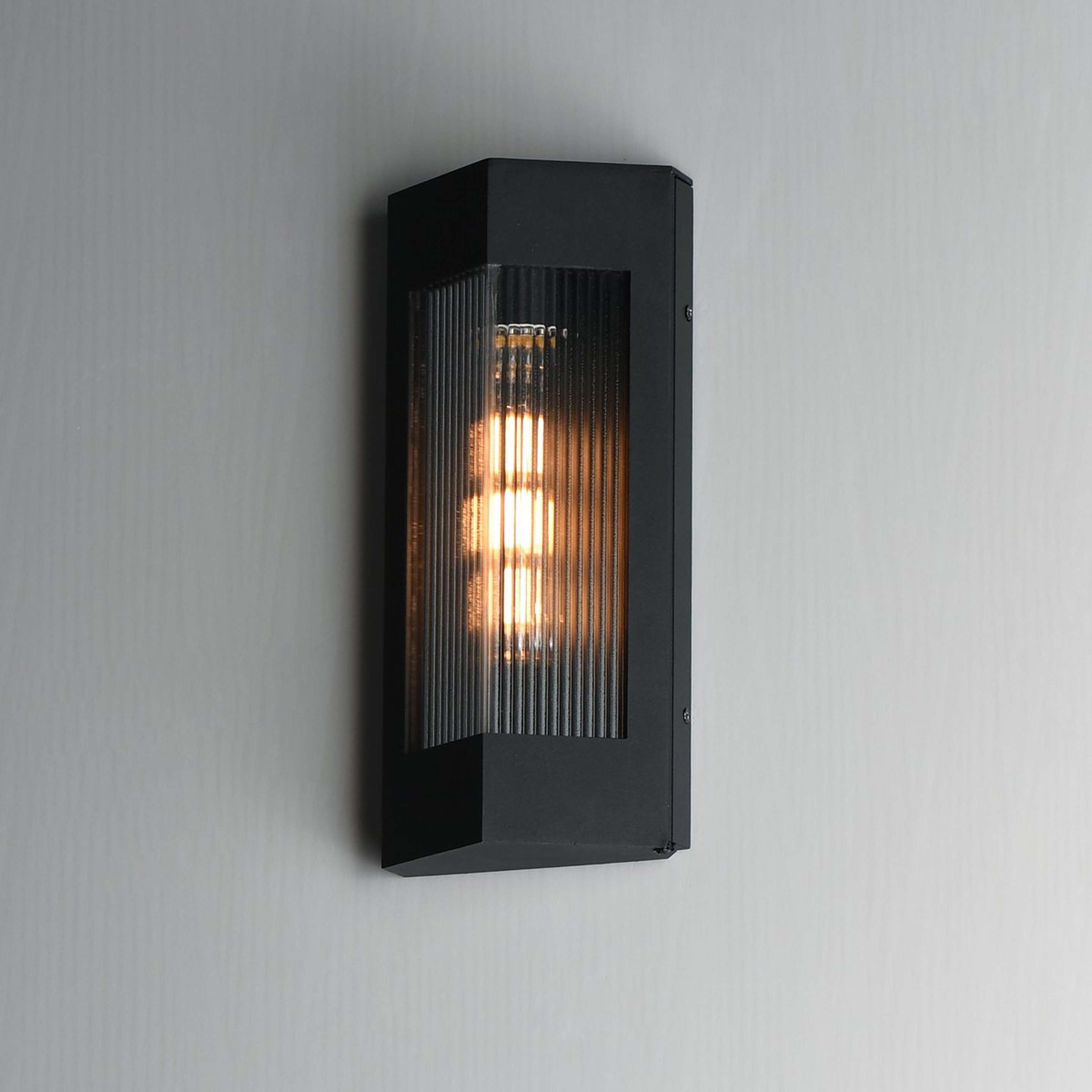 A Kimberly Outdoor Sconce with Black / Brass / Clear Ribbed Glass color