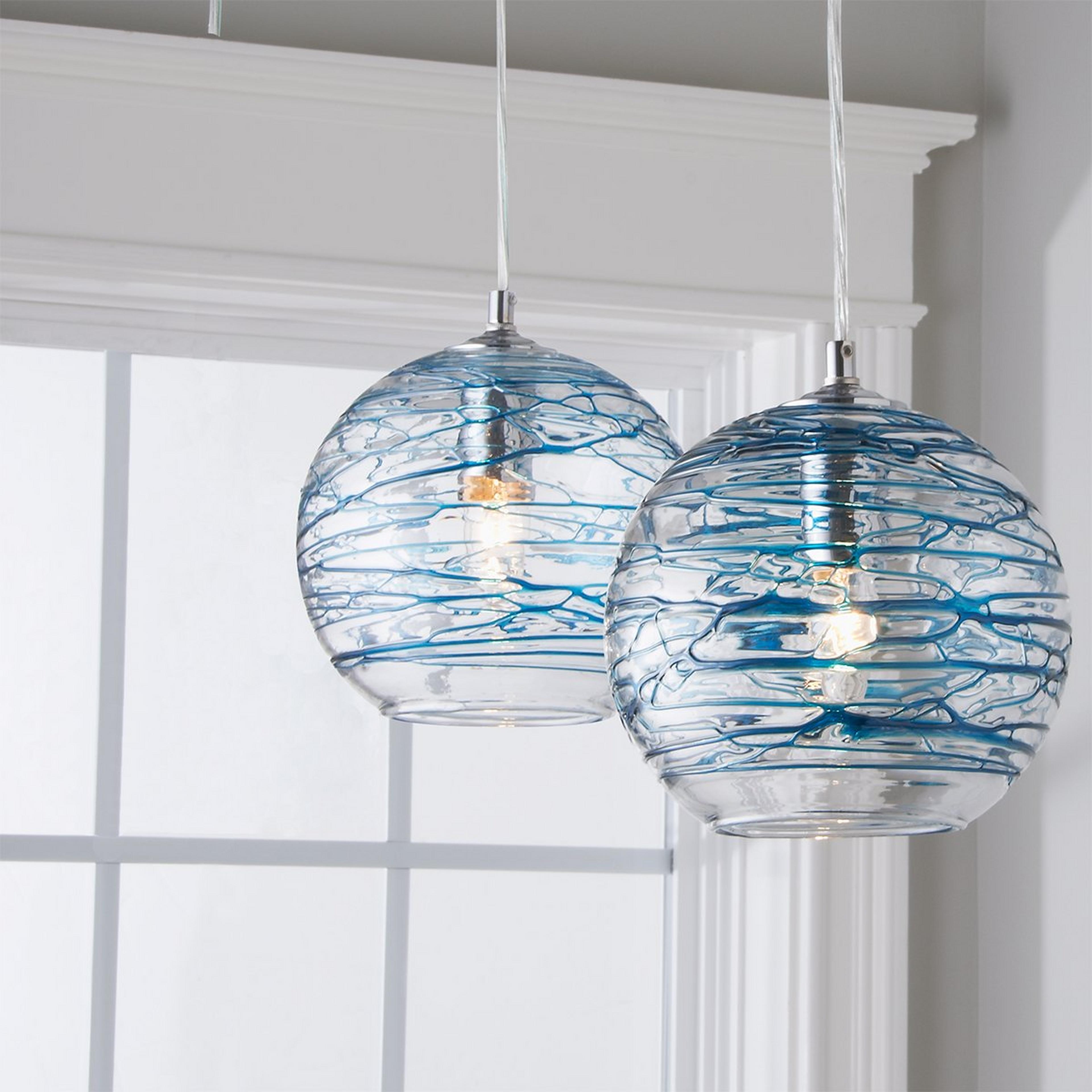 A Swirling Glass Globe Pendant with Chrome / Aqua color
