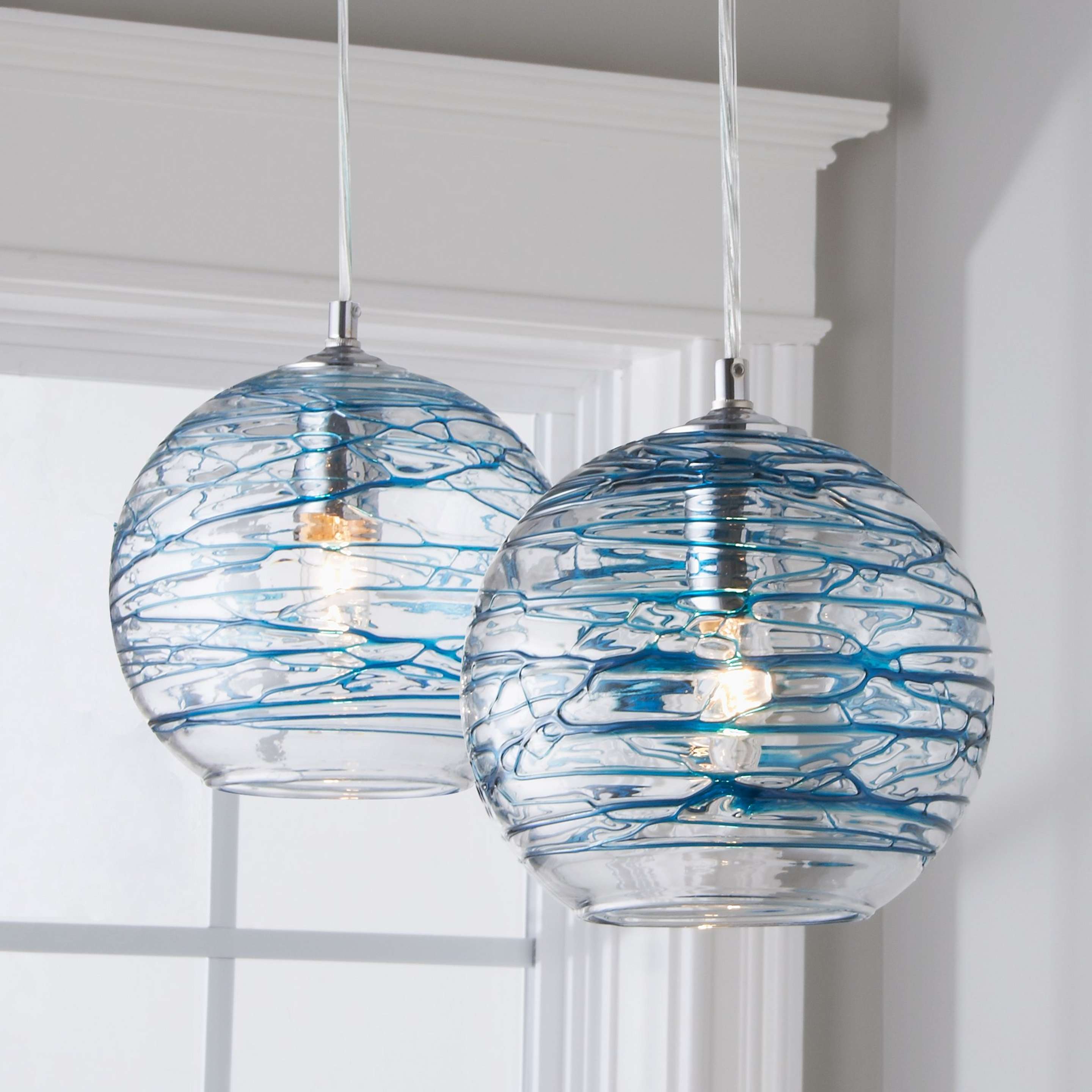 A Swirling Glass Globe Pendant with Chrome / Aqua color