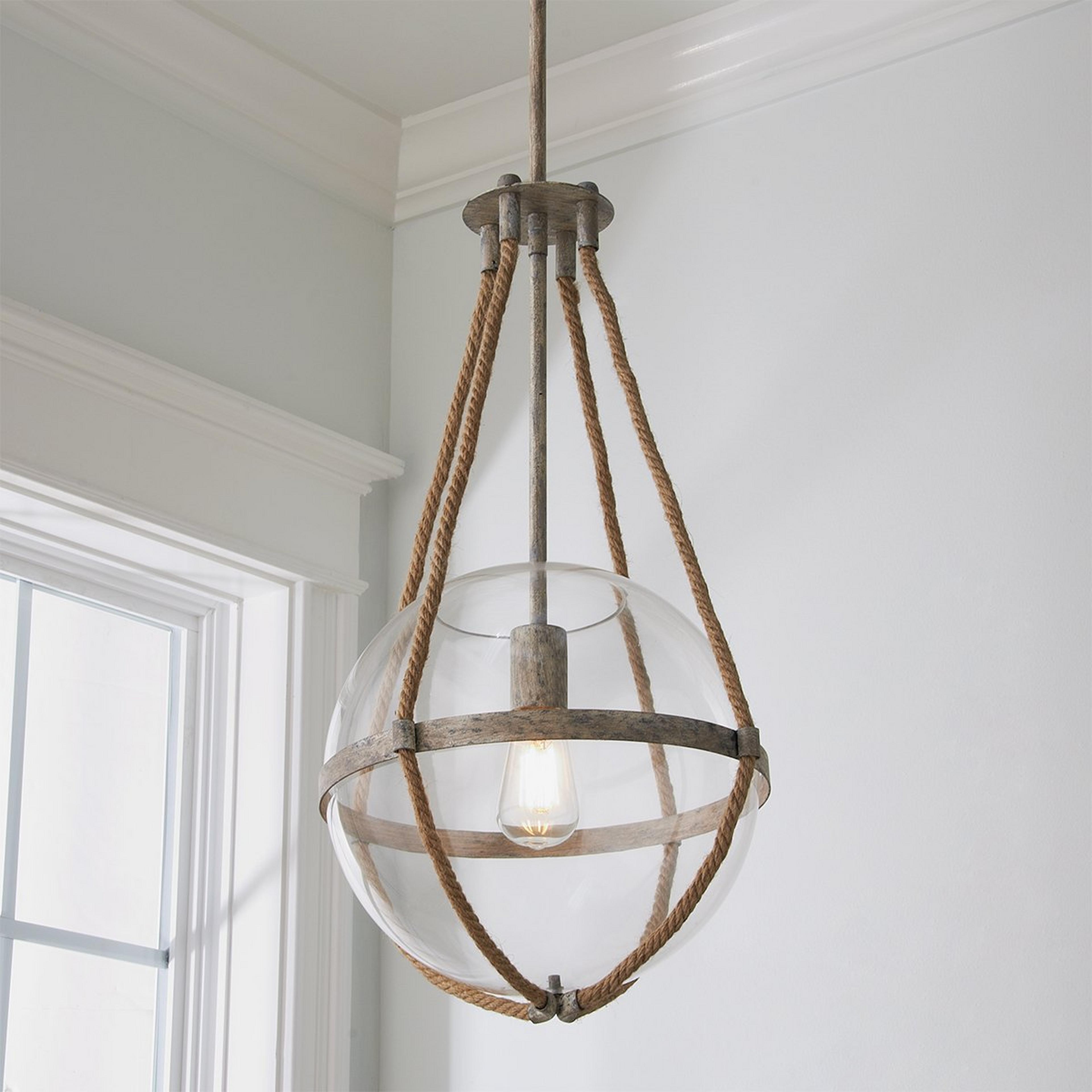A Coastal Cottage Rope Globe Pendant with Distressed Cream color