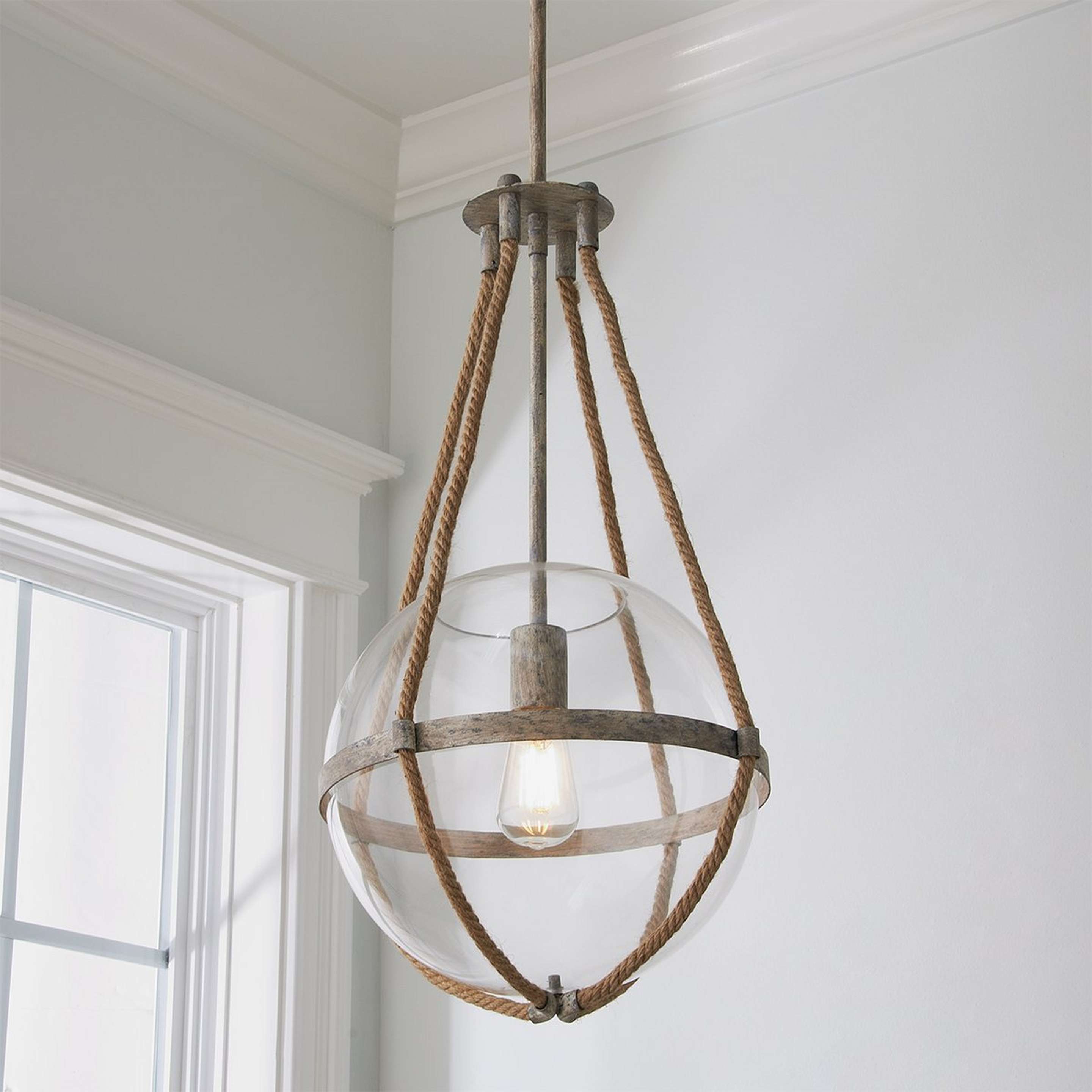 A Coastal Cottage Rope Globe Pendant with Distressed Cream color