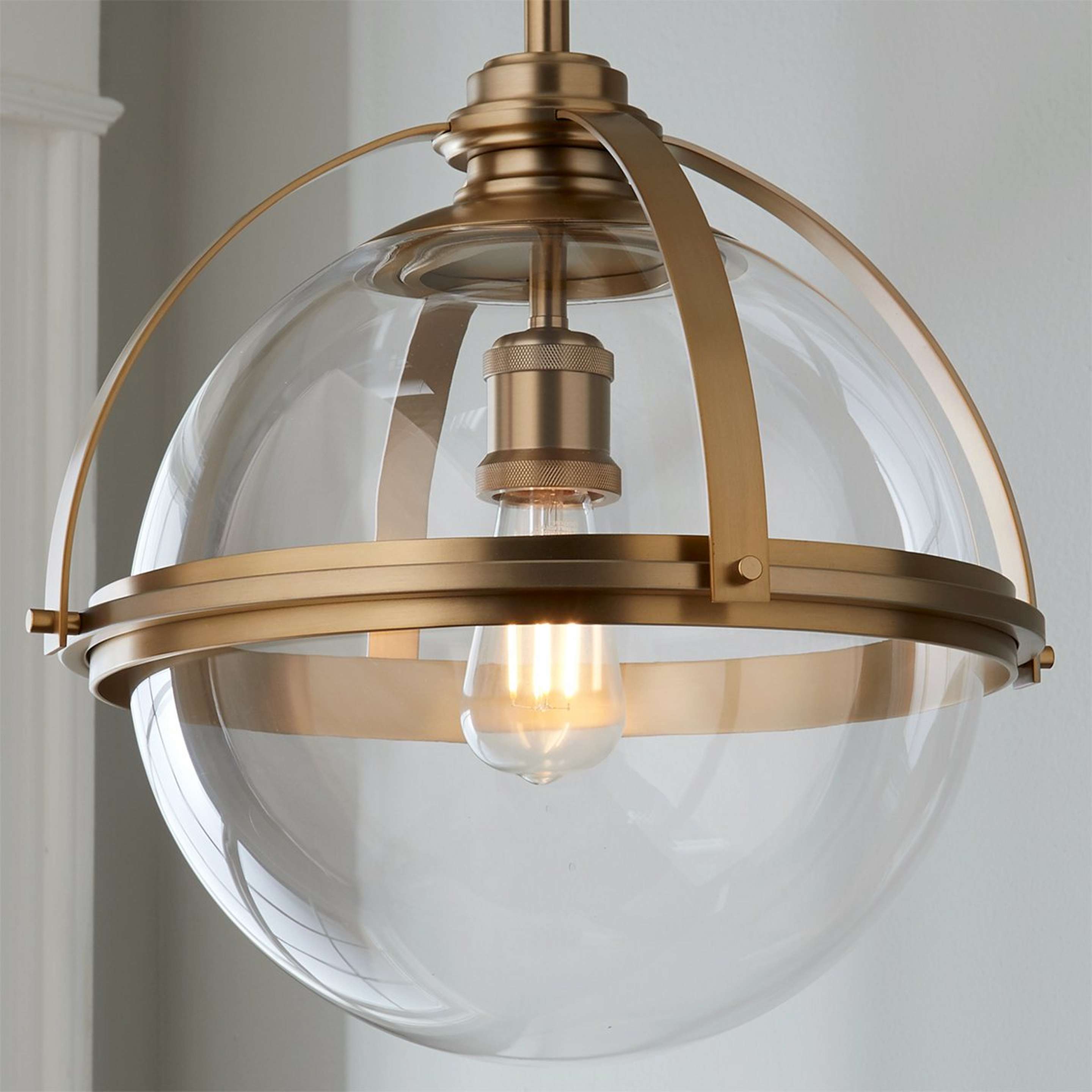 A Industrial Banded Globe Pendant - Medium with Aged Brass / Clear color