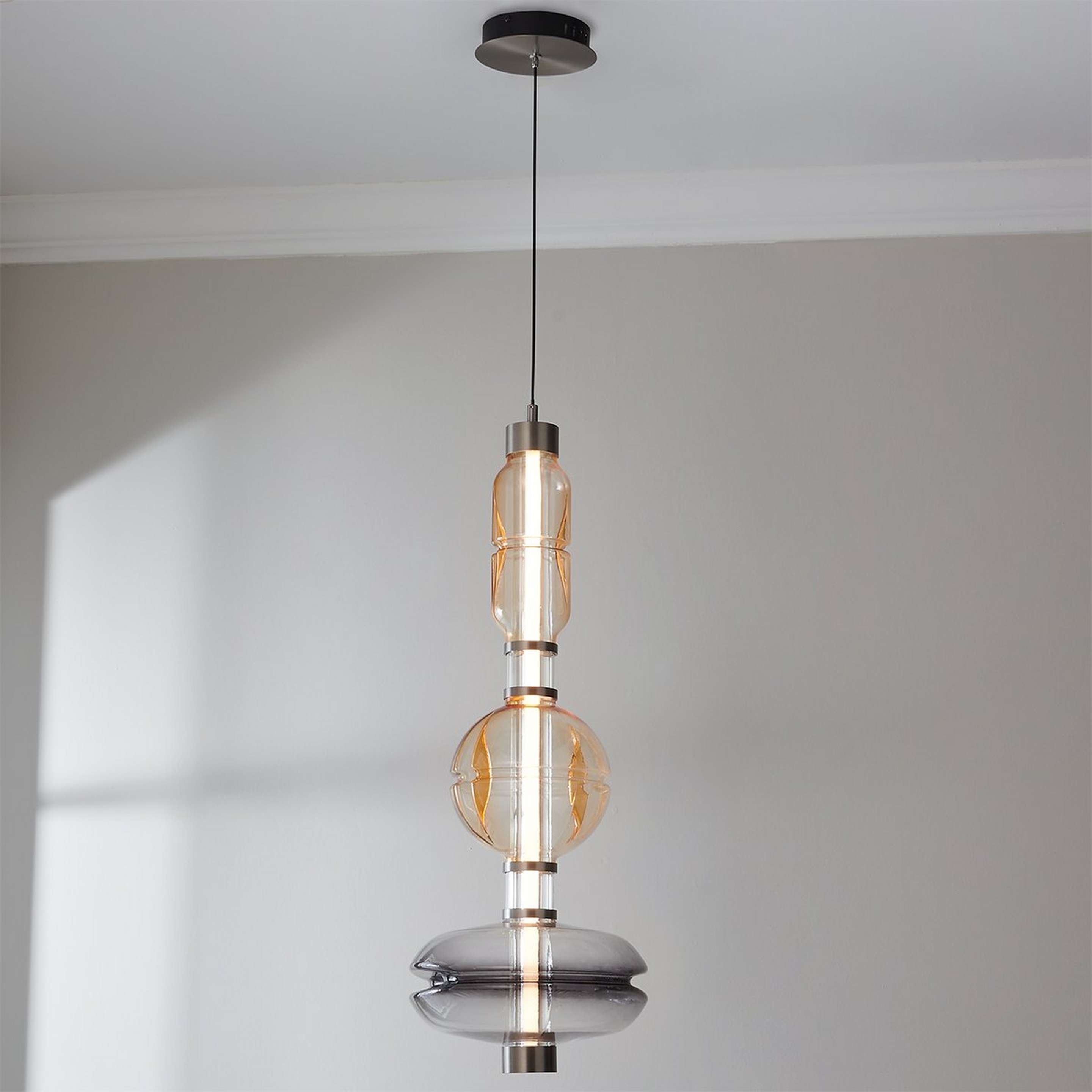 A Mokuteki Pendant with Gunmetal / Smoked Glass / Amber Glass color