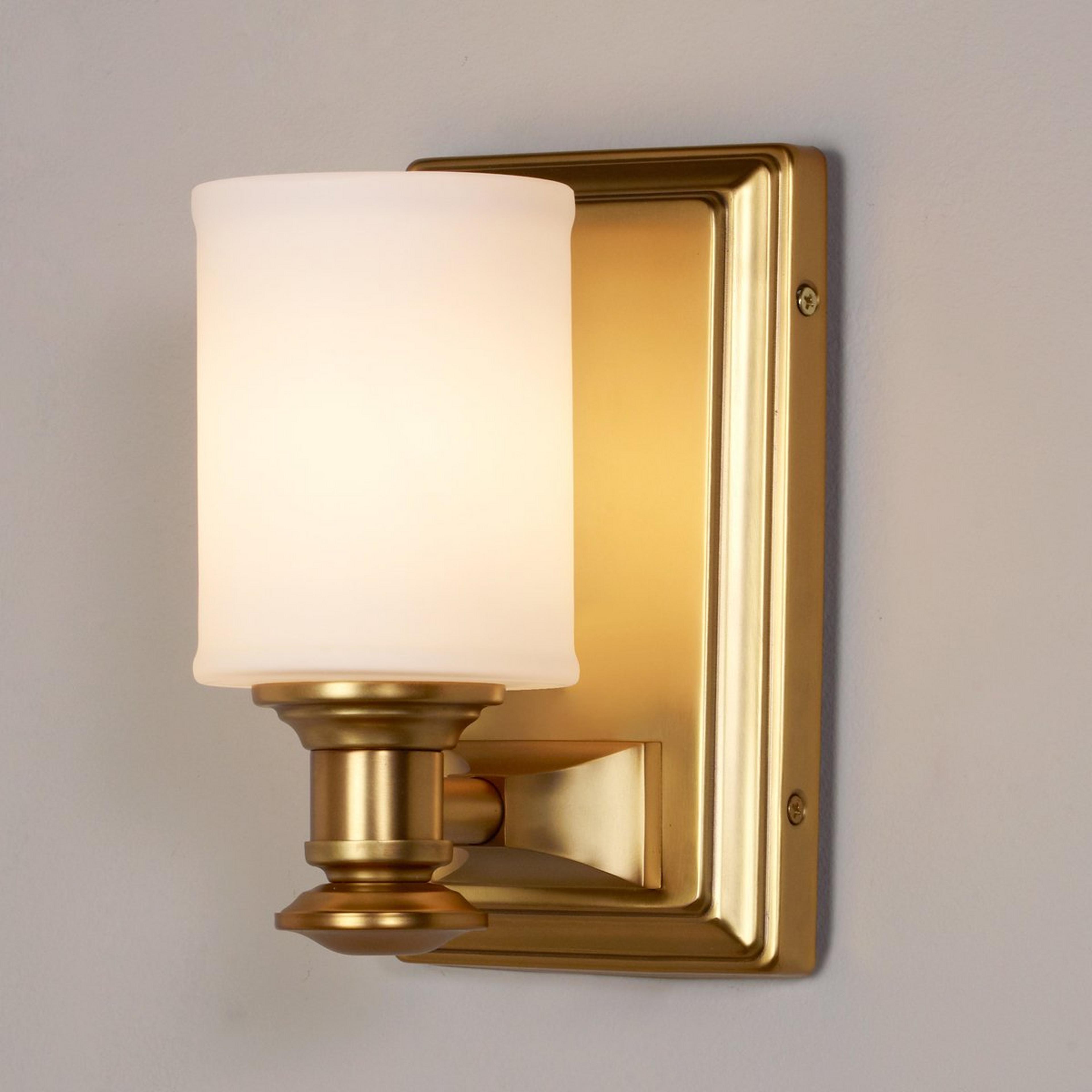 A Traditional Urban Sconce with Antique Gold / White Glass color