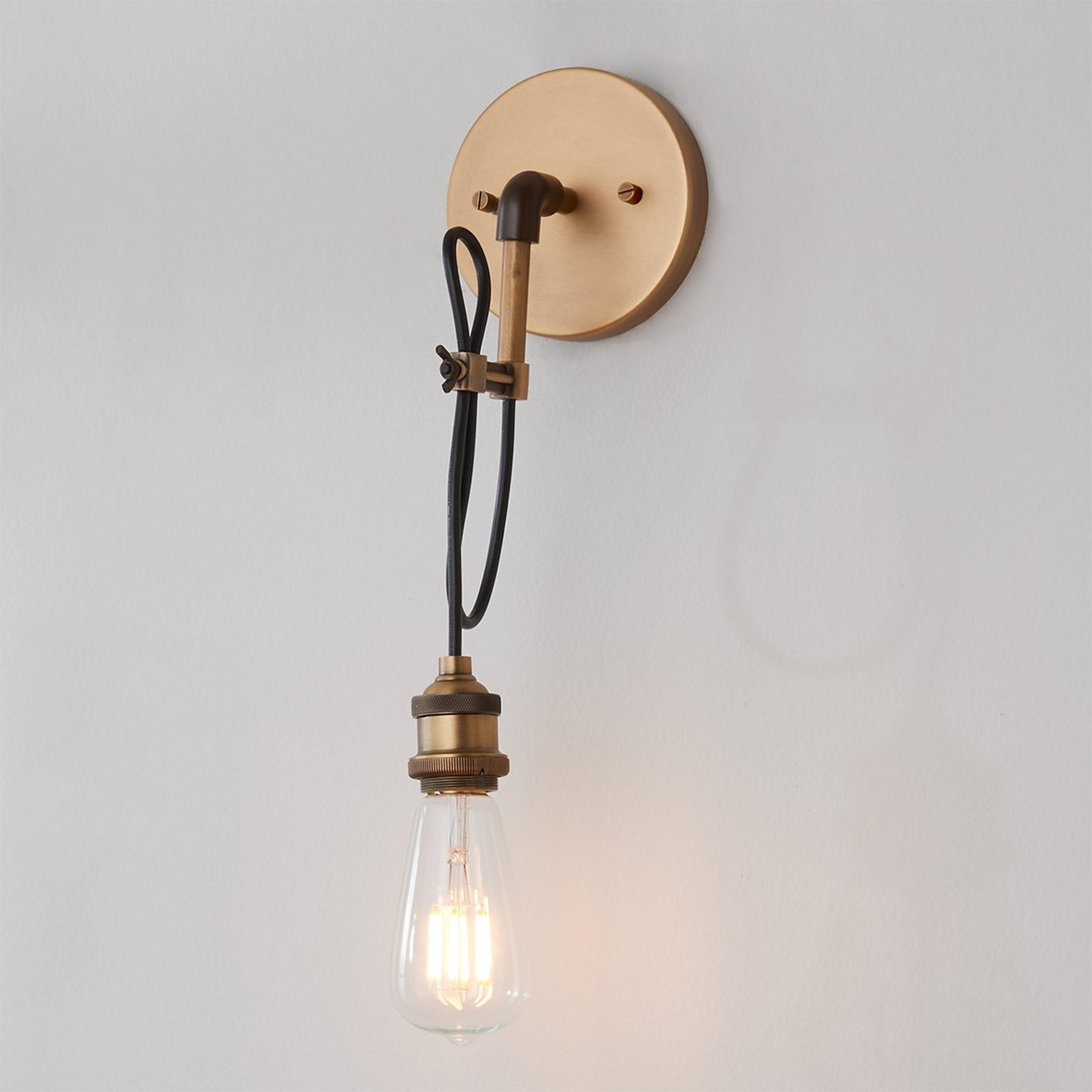 A Wired Industrial Convertible Wall Sconce and Pendant with Natural Brass color