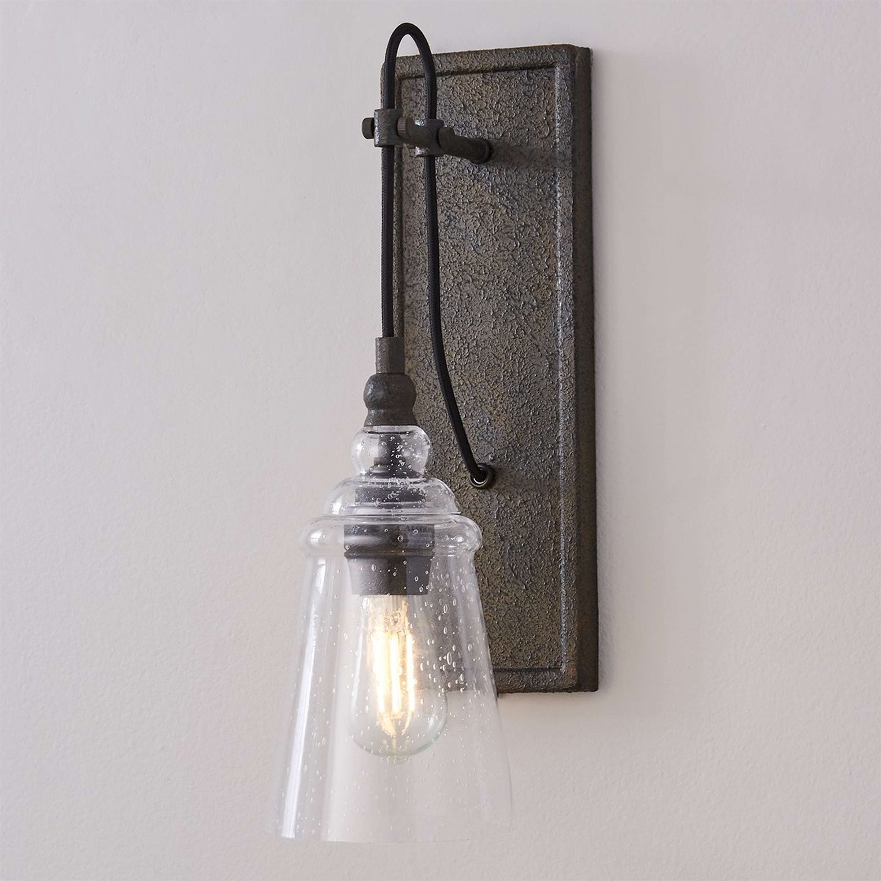 A Historic Industrial Seeded Sconce with Dark Weathered Iron color