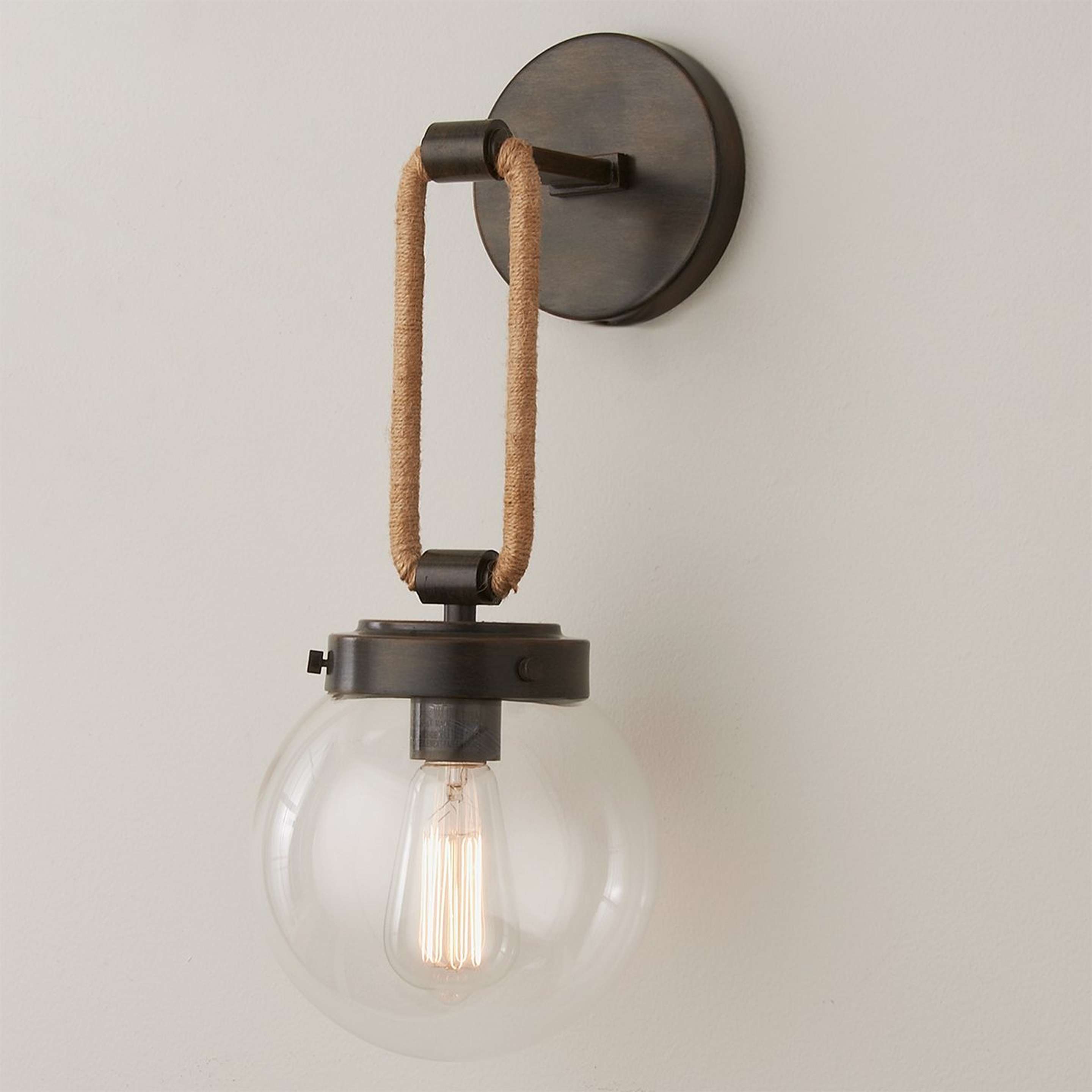 A Coastal Cottage Rope Globe Sconce with Distressed Warm Bronze color