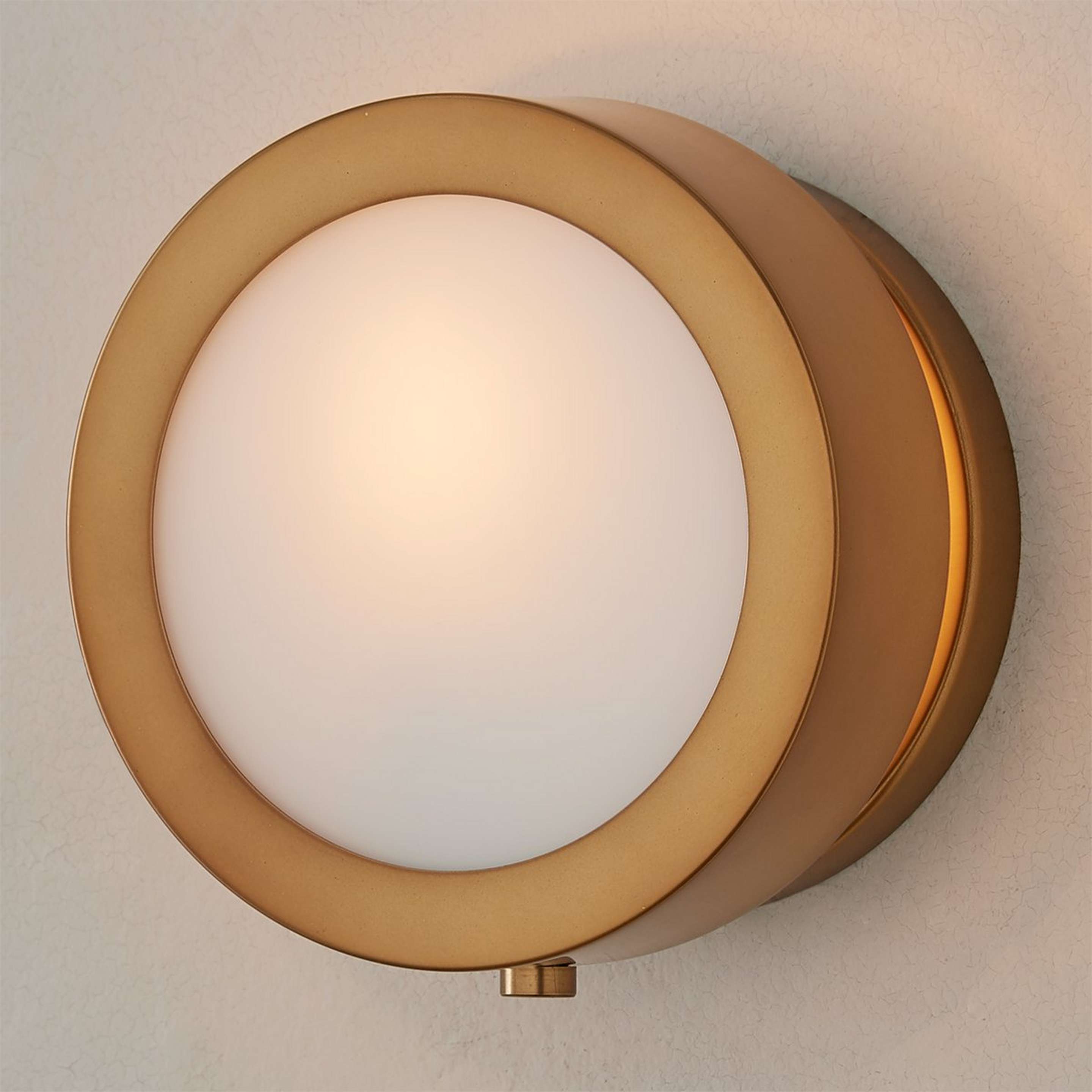 A Midcentury Glow Lens Sconce with Heritage Brass color