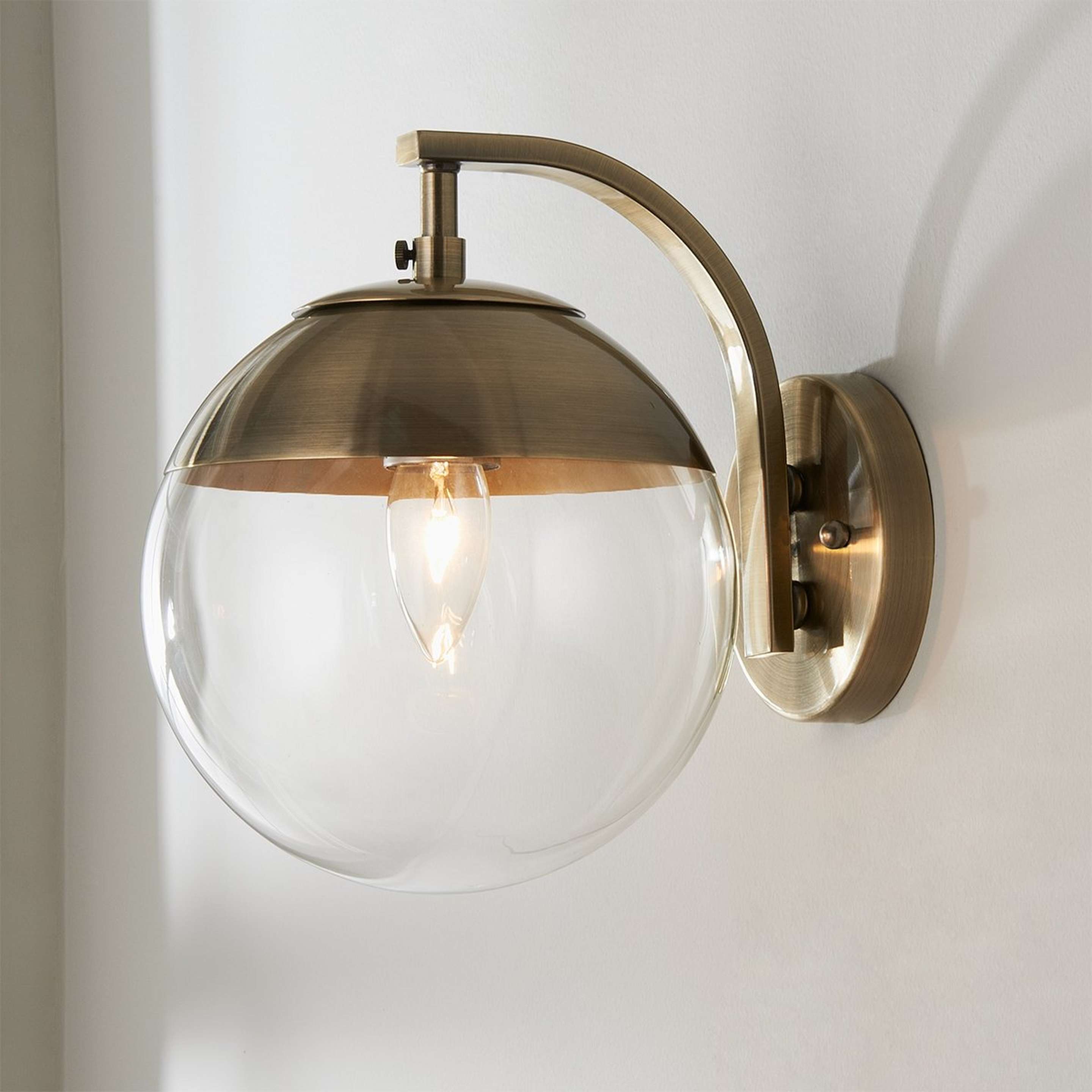 A Mid-Century Clear Globe Sconce with Antique Brass / Clear color