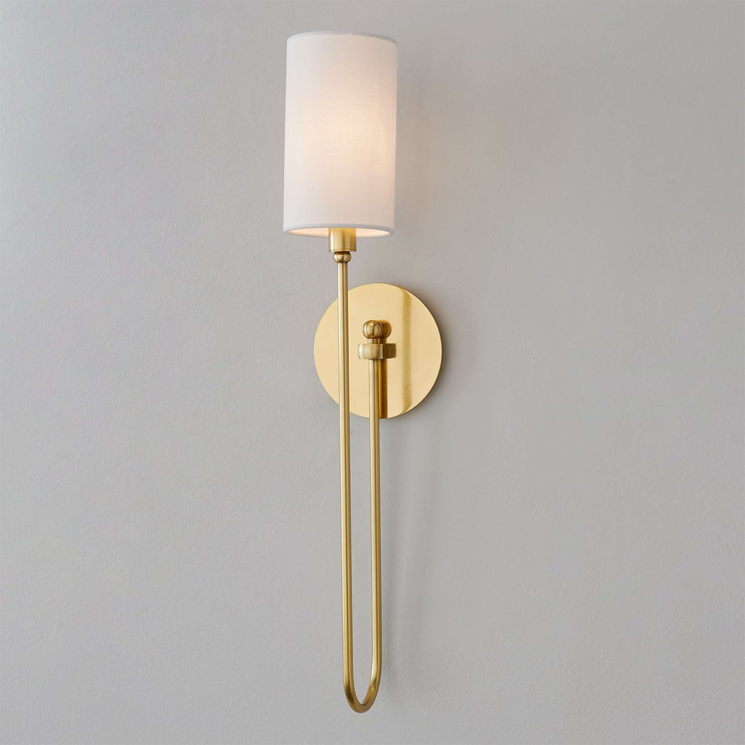 A Callie Sconce with Aged Brass color