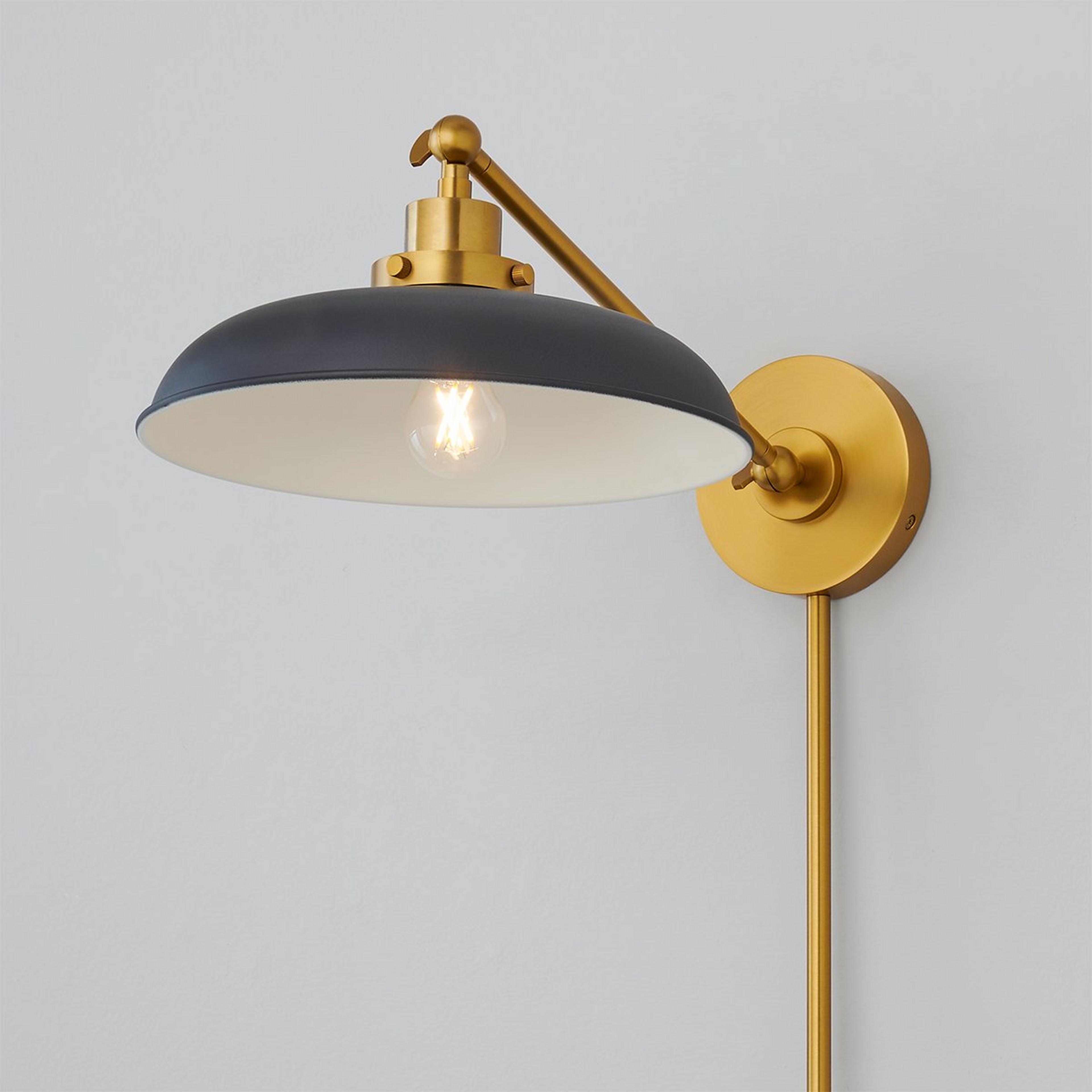 A Blakemore Swing Arm Sconce with Midnight Black / Burnished Brass color